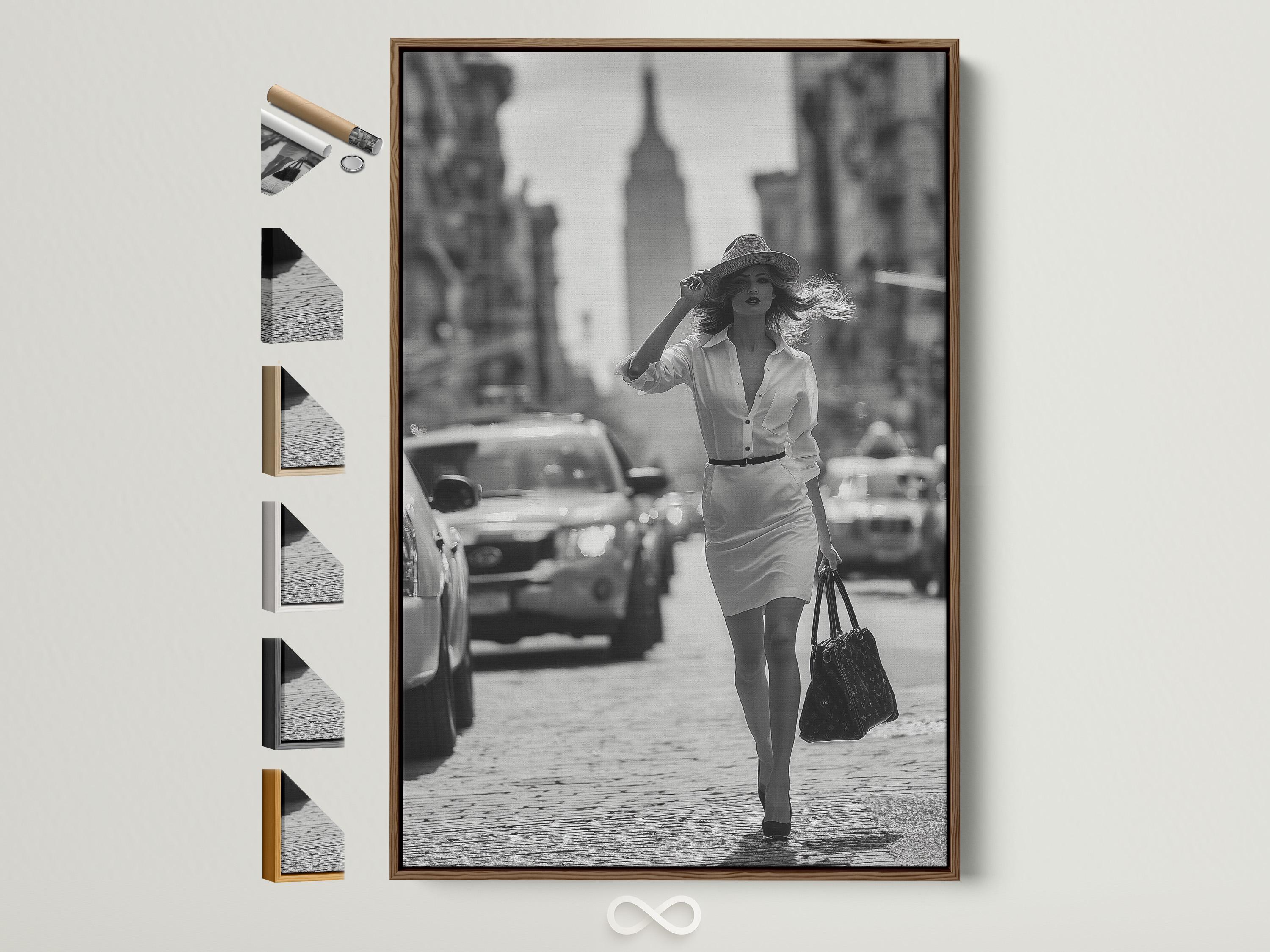 A black-and-white street photograph shows a stylish woman walking forward with a hat and handbag, with blurred city buildings and cars behind her