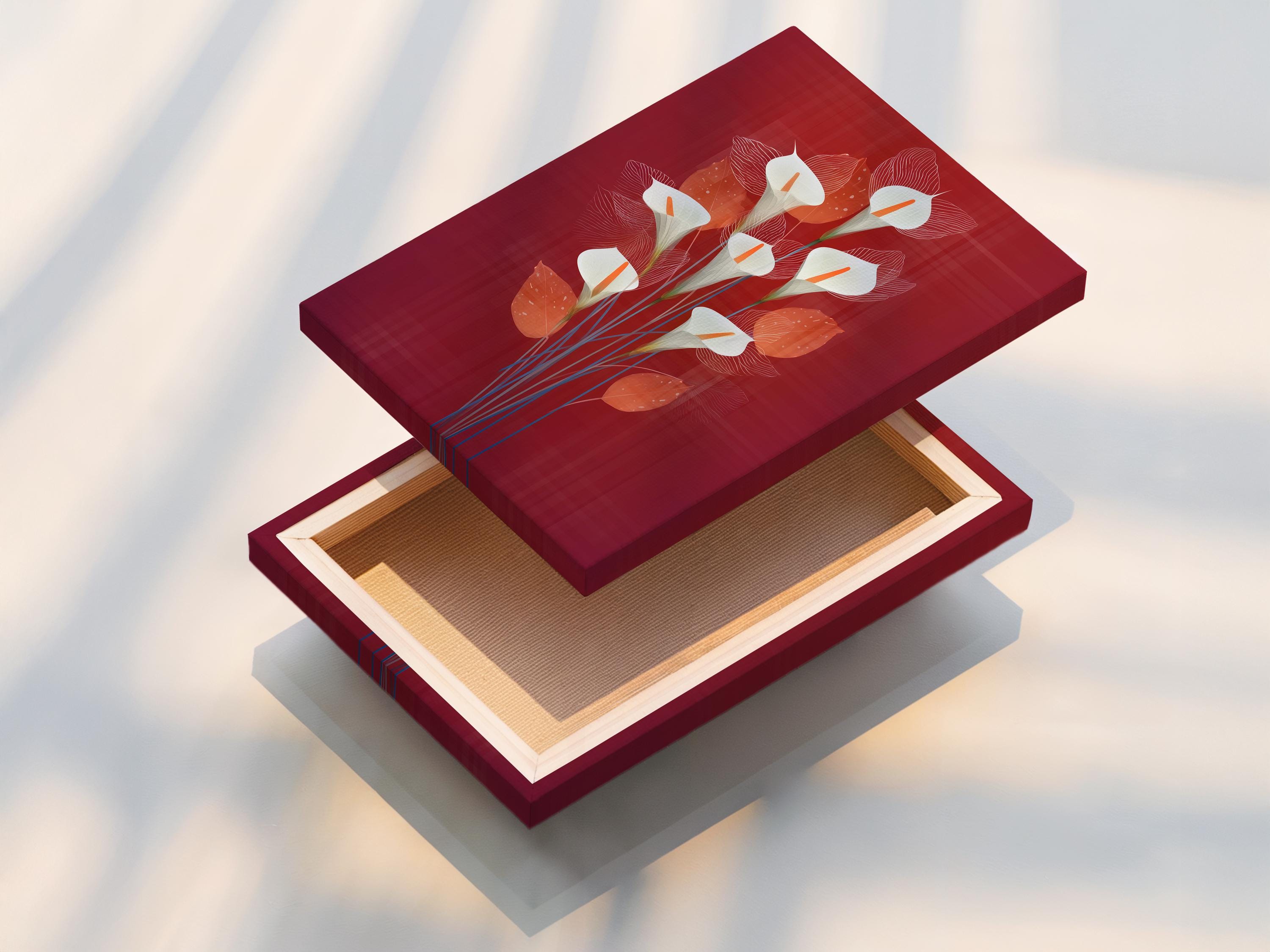 Stylised calla lily bouquet with white flowers, orange centres and blue stems on a burgundy background detail view