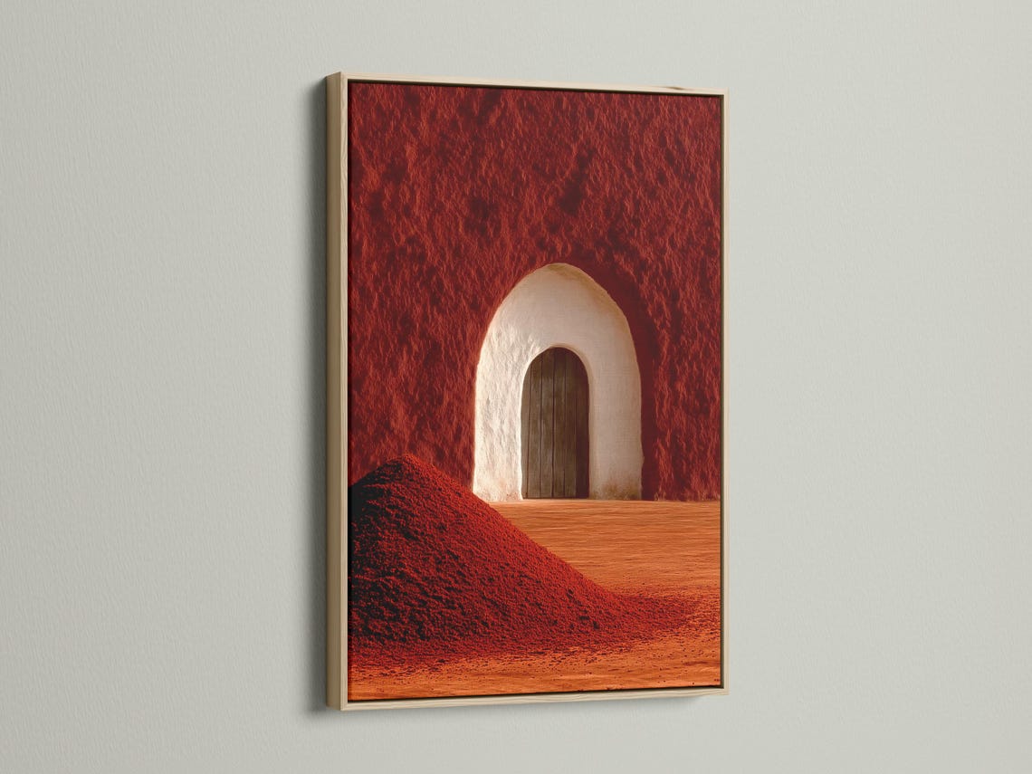 Warm red and terracotta desert arch doorway with a pale arch and wooden door panel detail view