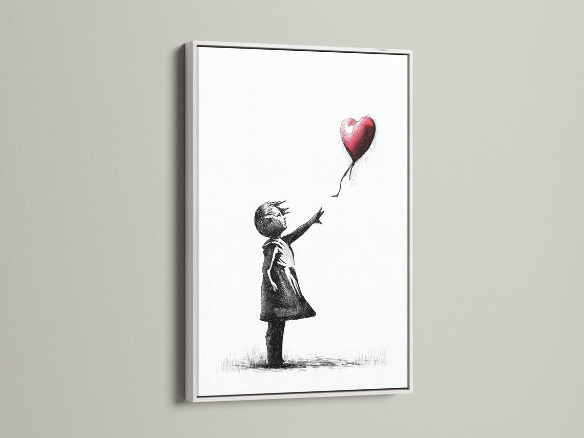 Room mockup showing a framed black and white girl sketch with a red heart balloon