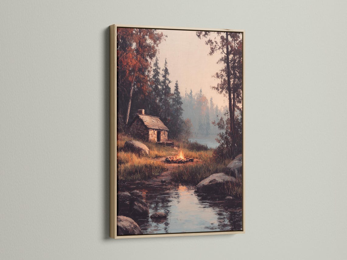 Wood-framed artwork of a rustic cabin scene in a product mockup view