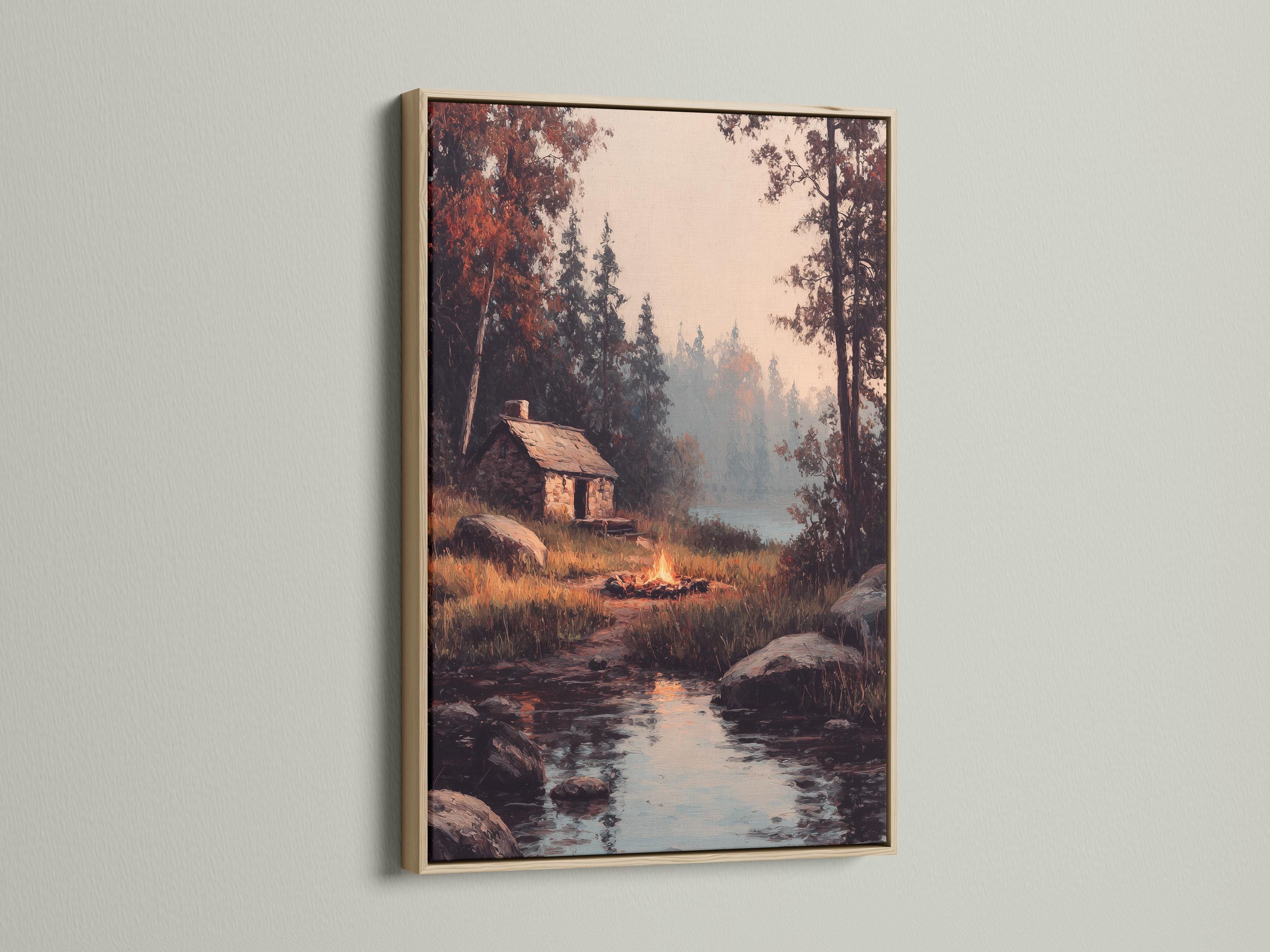 Wood-framed artwork of a rustic cabin scene in a product mockup view