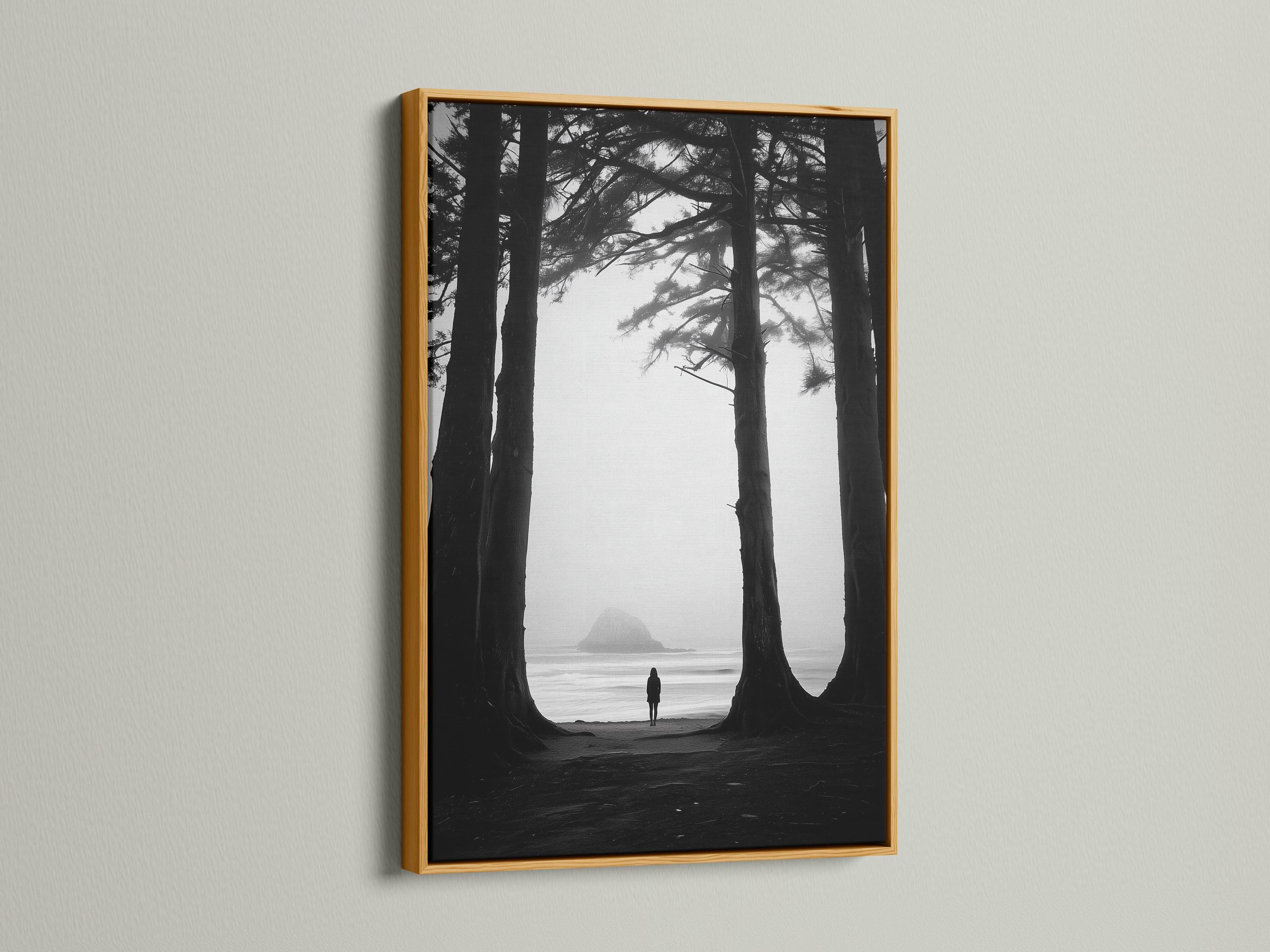 Monochrome seascape with dark tree trunks framing a foggy beach and a small lone figure detail view