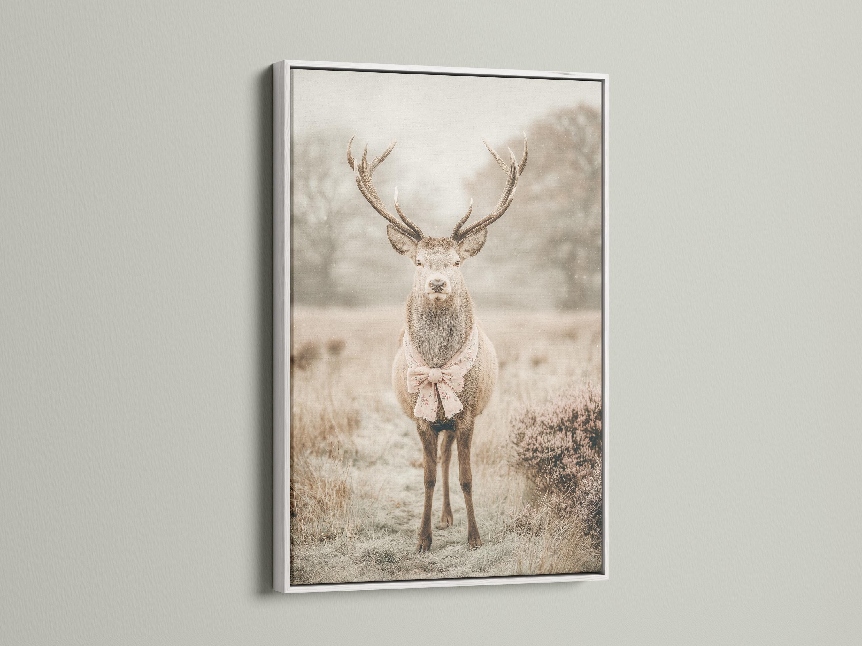 Deer portrait with raised antlers in a misty field, wearing a pale pink bow detail view