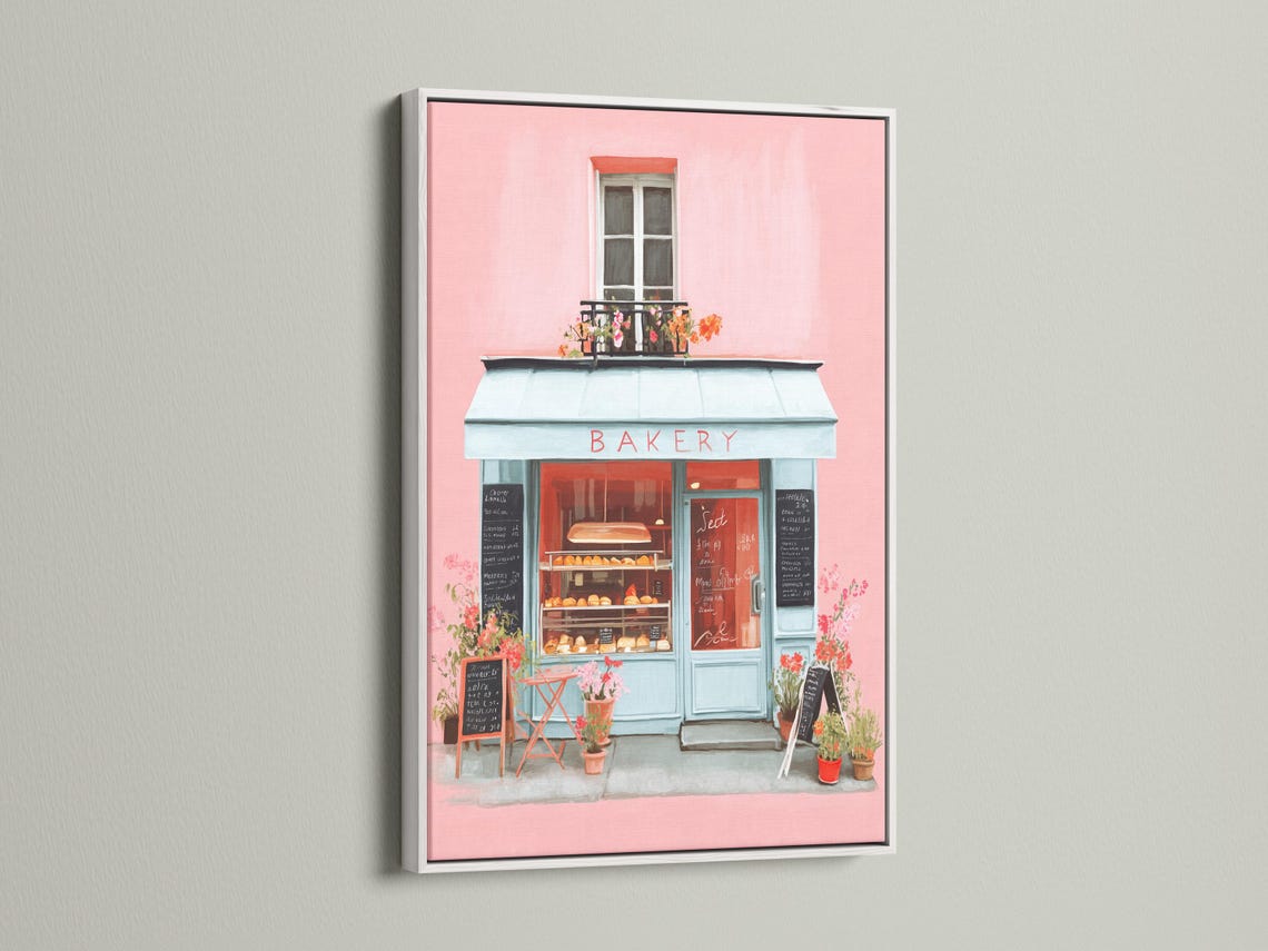 Room mockup showing a framed pastel bakery shopfront illustration
