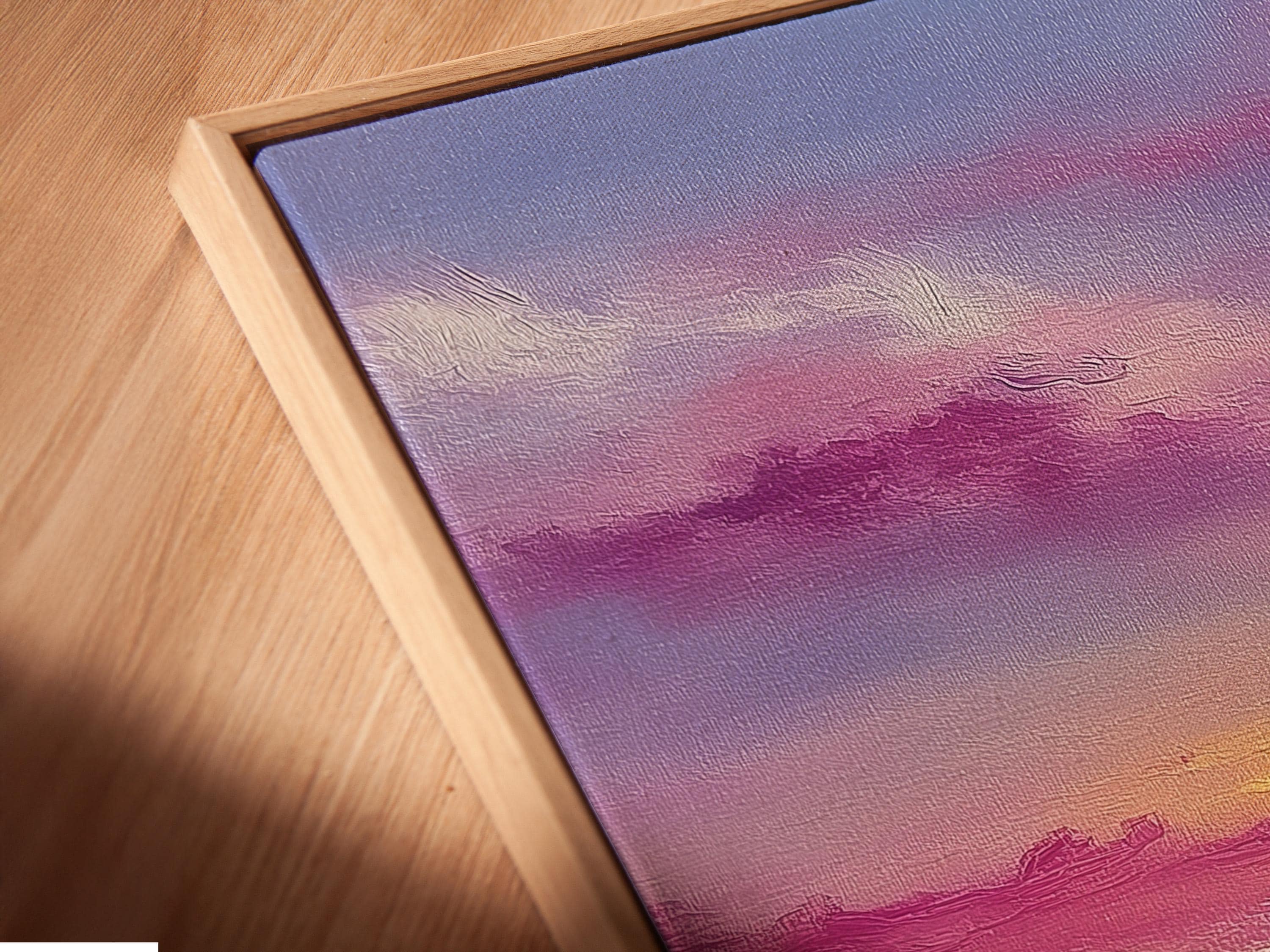 A framed mountain sunset illustration with purple, pink and gold skies and small black birds detail view