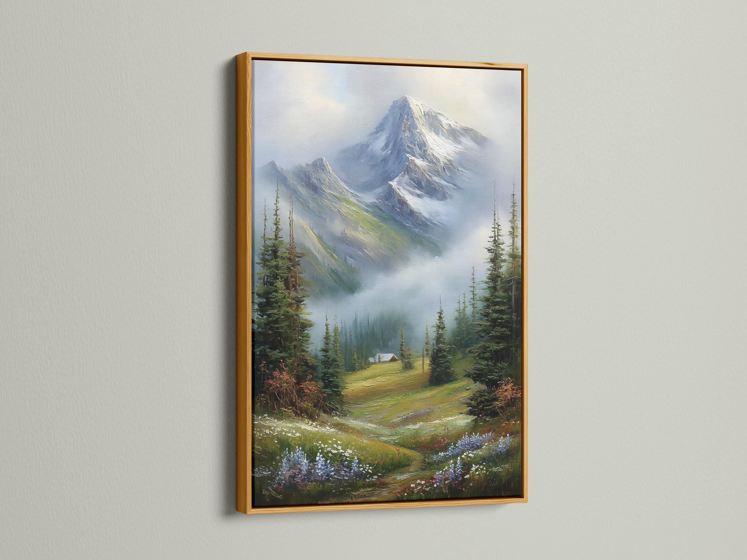 Room mockup showing a framed snowy mountain landscape painting with evergreen trees and a cabin