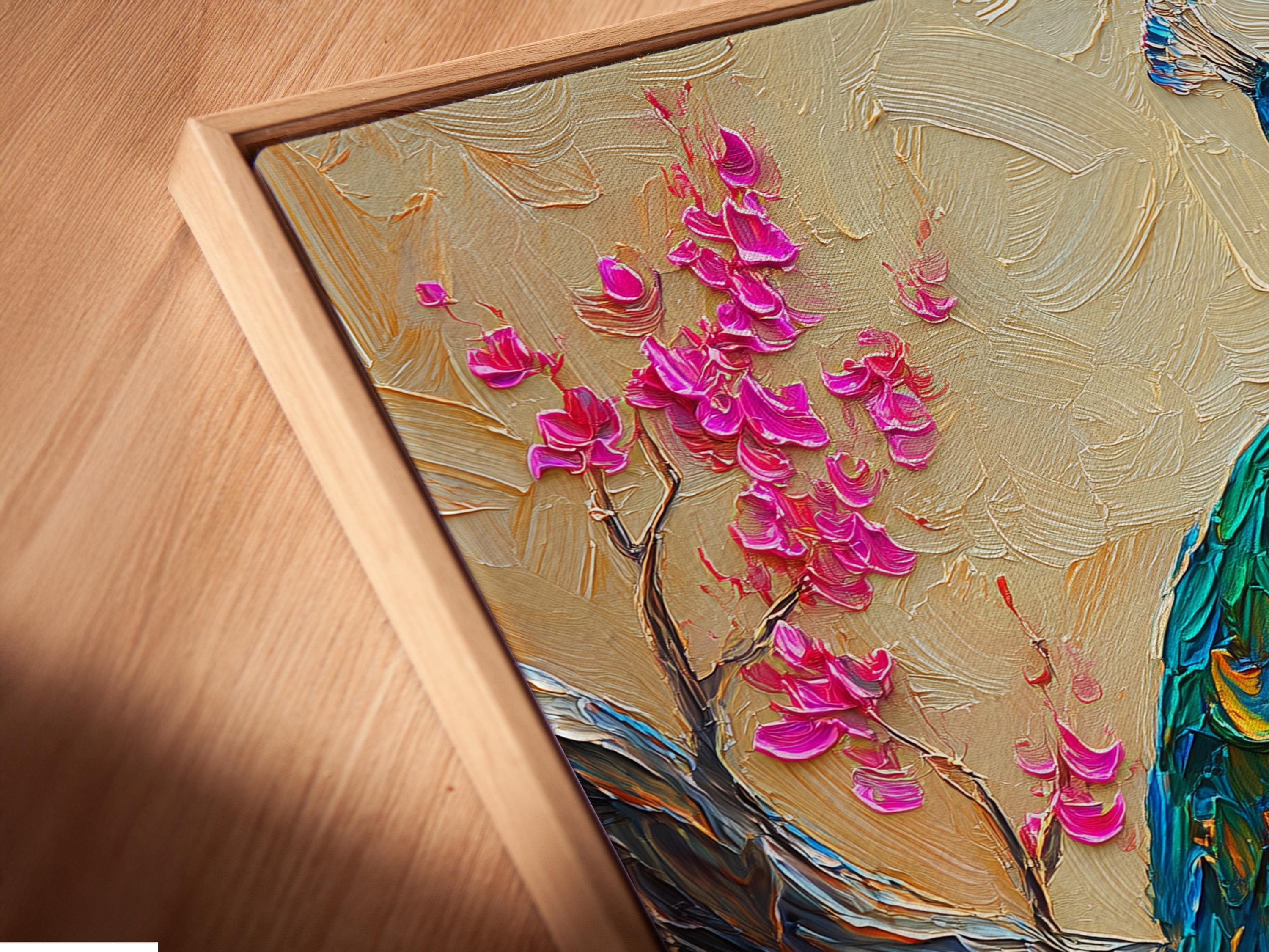 Vibrant peacock with jewel-toned blue feathers beside pink cherry blossom branches on a cream textured background detail view