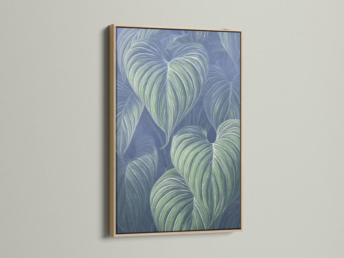 Mockup showing a framed botanical leaf artwork with mint green leaves on a navy-blue background