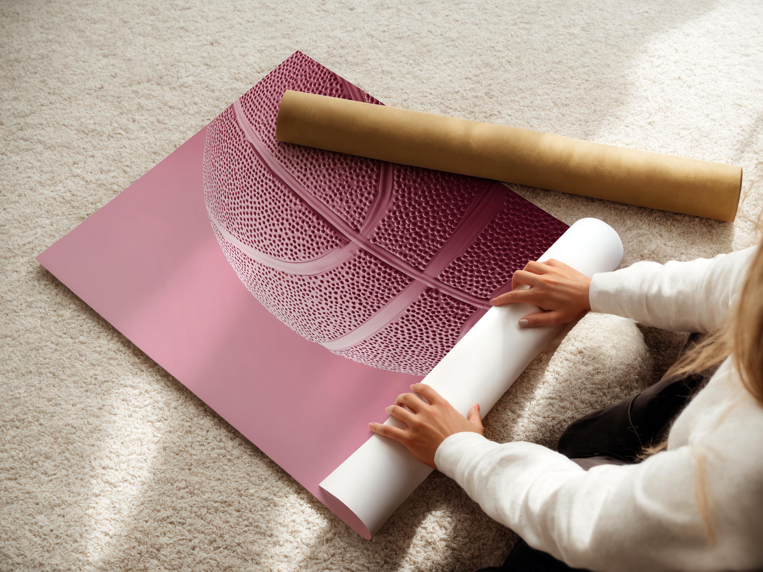 Woman sitting on a sofa beside a framed bubblegum pink basketball artwork