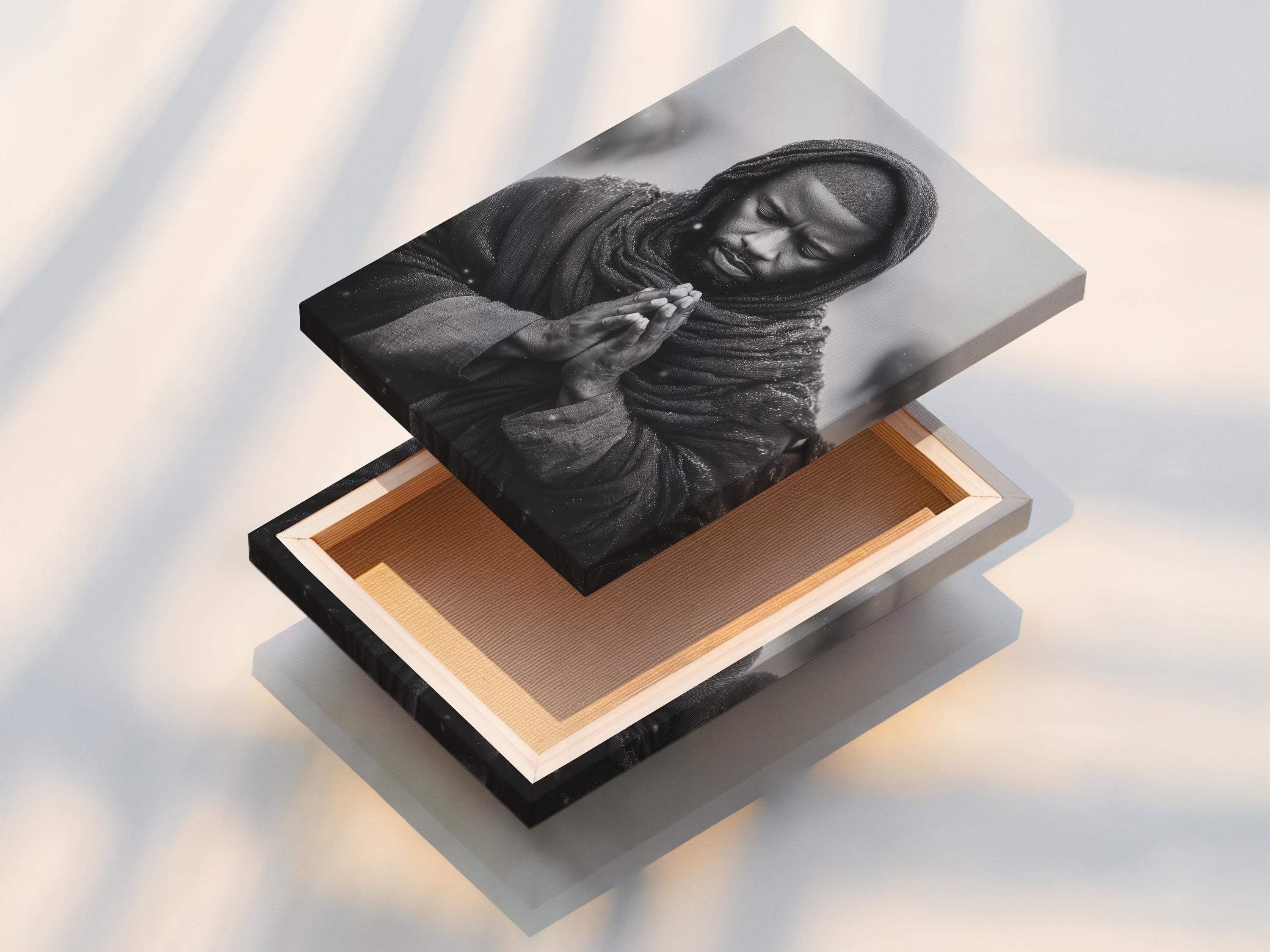 Room mockup showing a framed monochrome praying man portrait on a light background