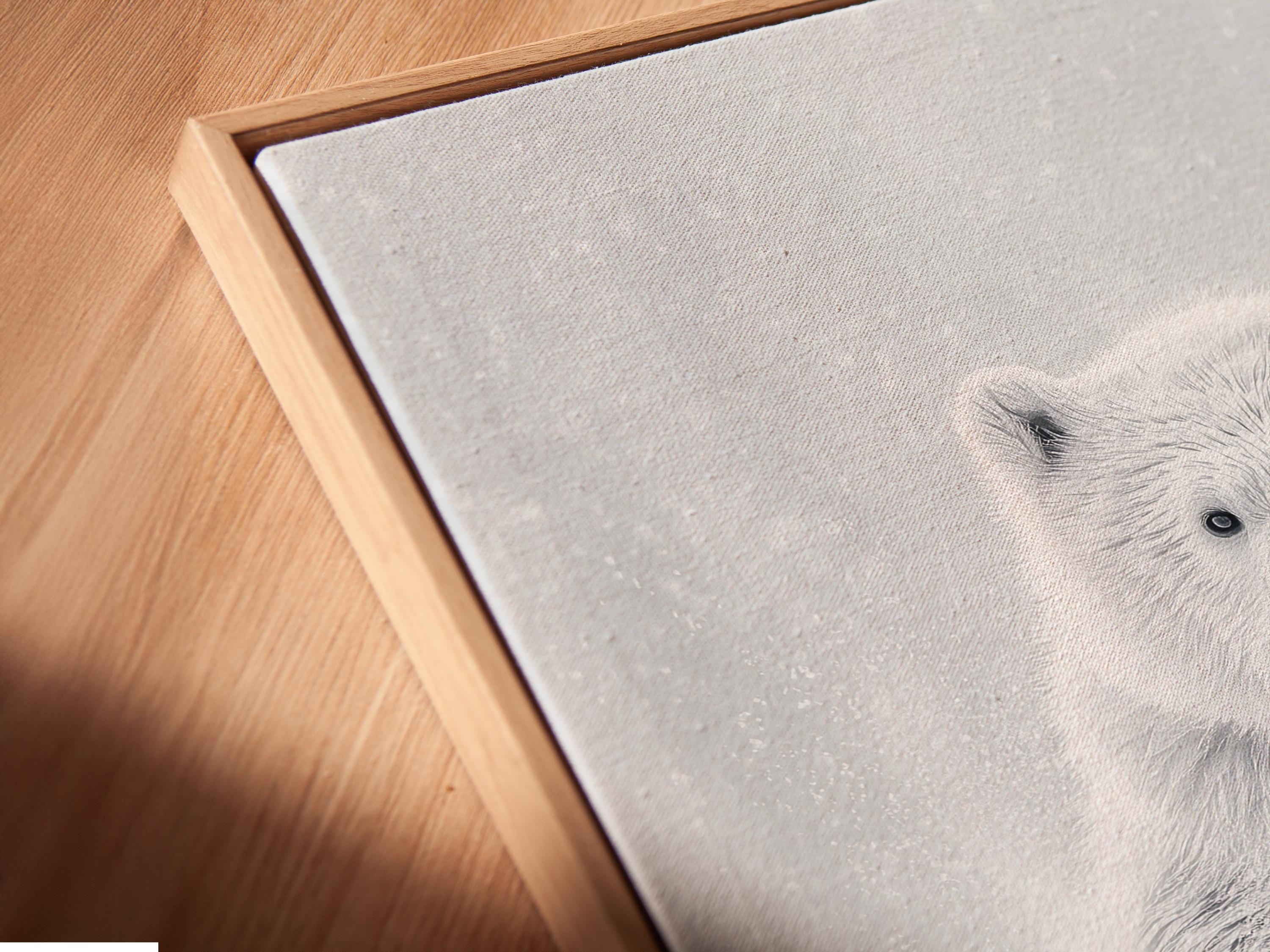 Room mockup showing a framed monochrome polar bear running artwork