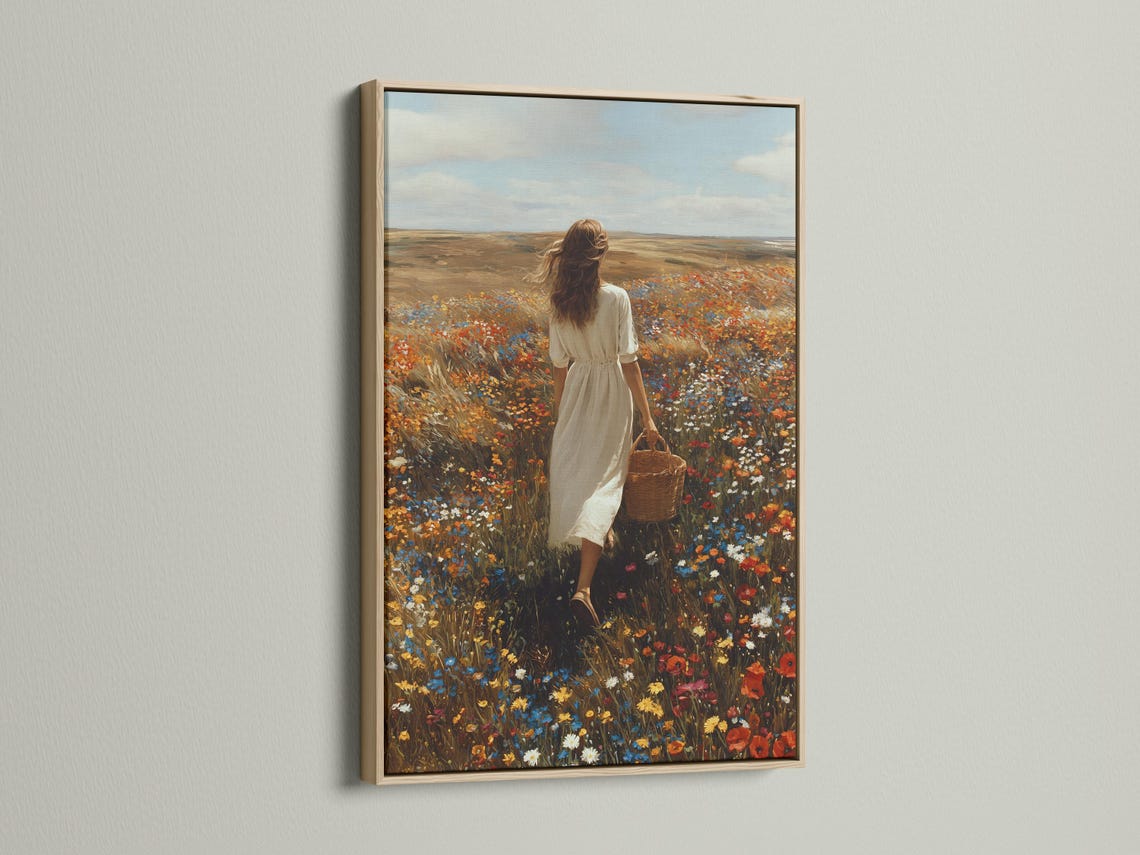 Mockup showing framed wildflower meadow artwork with a woman walking in a field of flowers