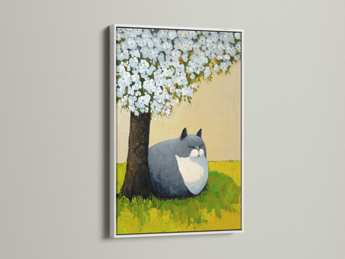 Grey and white cat lying on green grass beneath a tree with white blossoms detail view