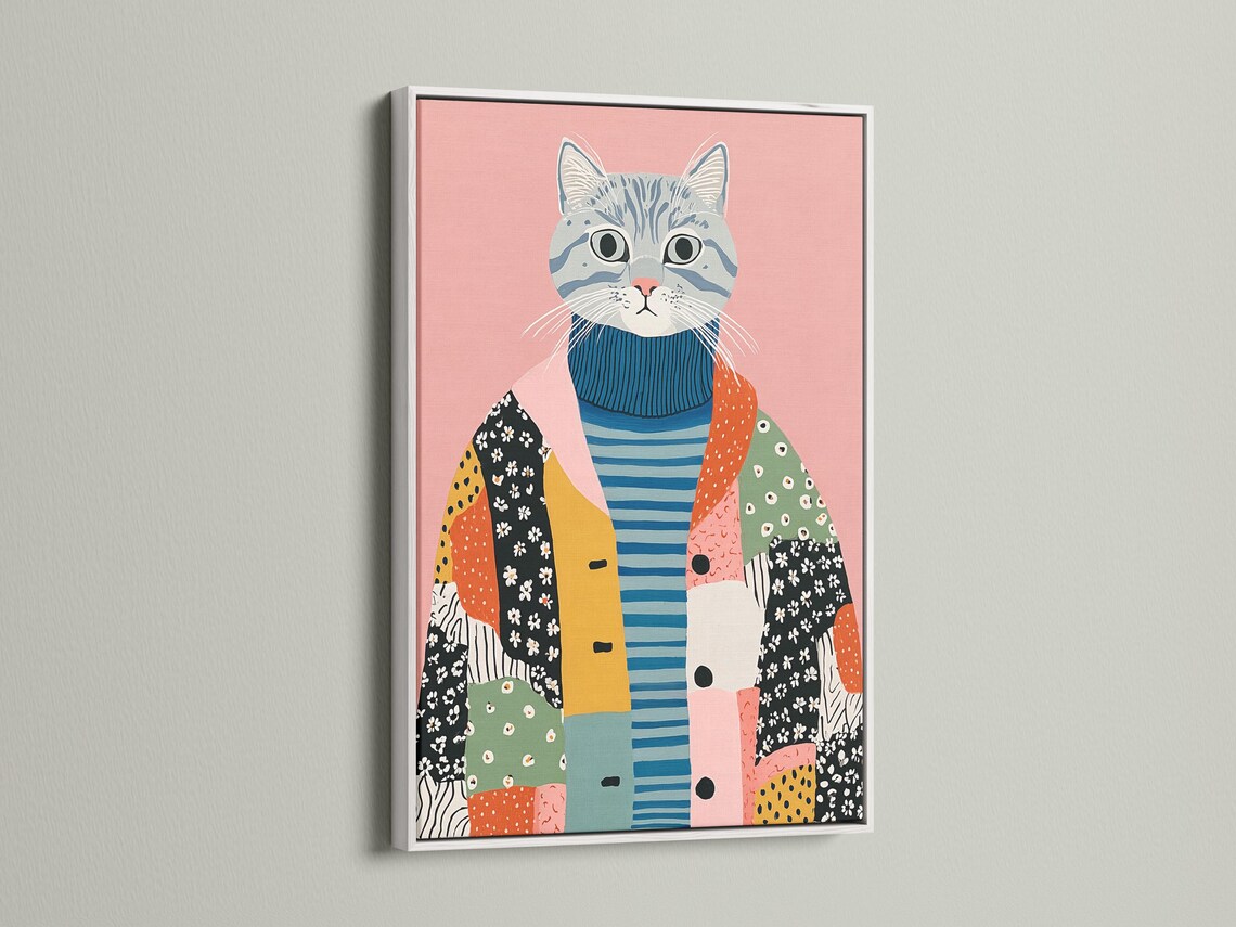 A pink background cat portrait wearing a blue striped sweater with patchwork shapes below detail view