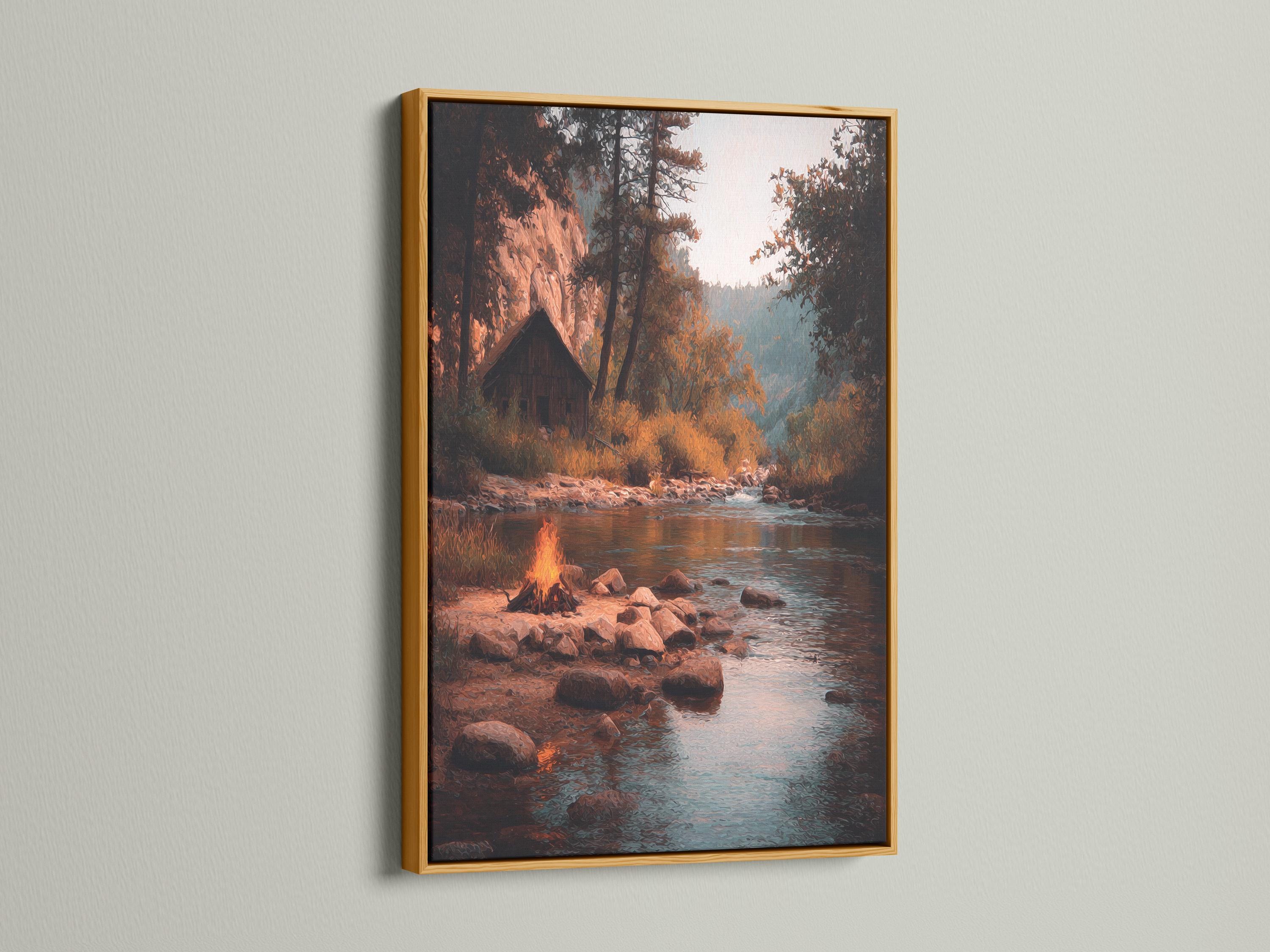 Moody river landscape with a warm campfire glow, rocks, trees and reflections on teal water detail view