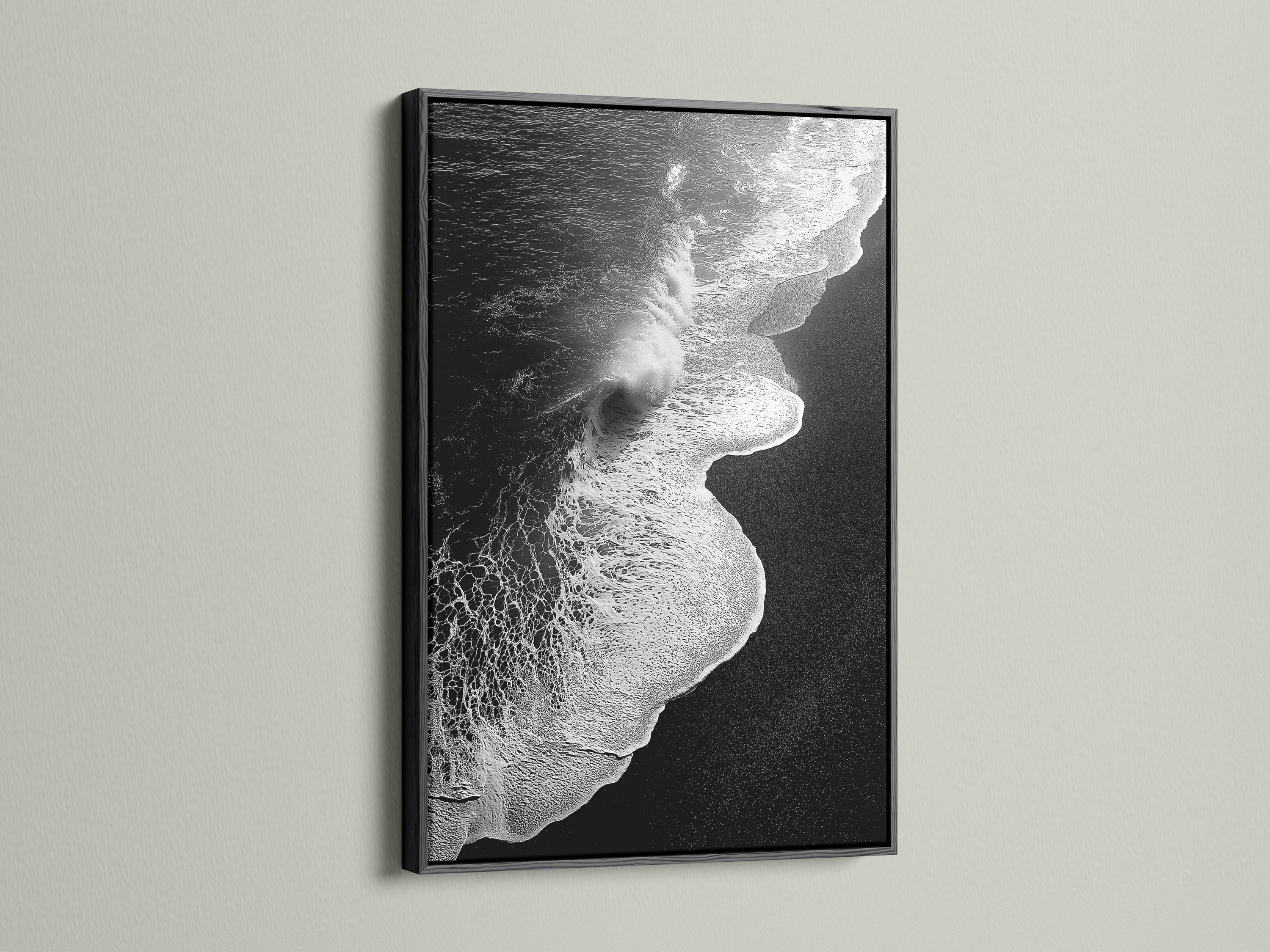 A monochrome seascape shows a foamy wave curling in bright white against deep black water, with a high-contrast, textured finish detail view