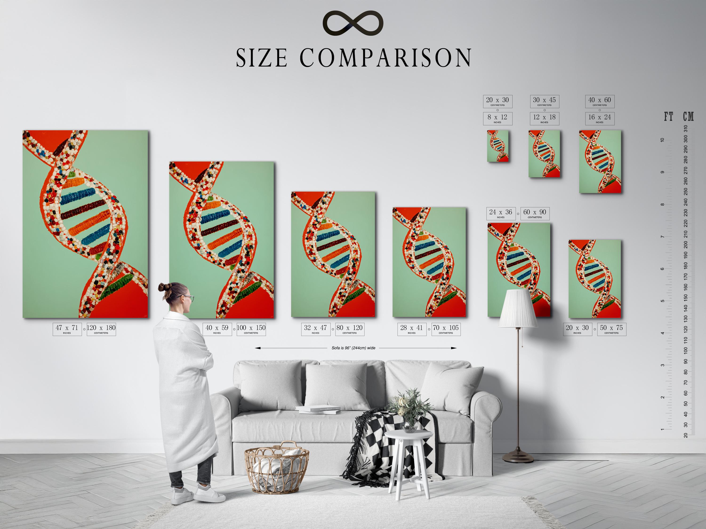 A researcher in a white lab coat stands next to a framed DNA double helix artwork