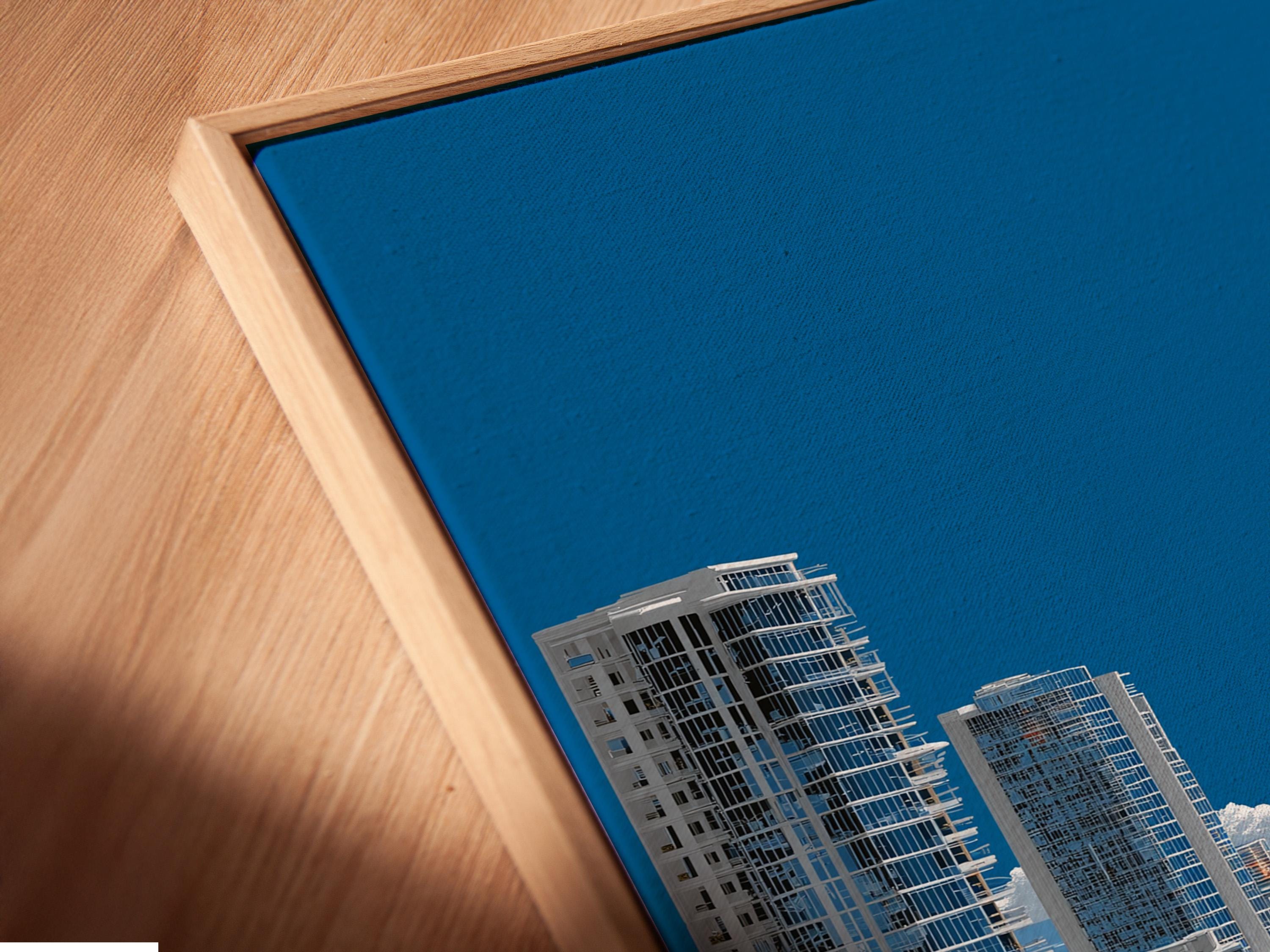 Room mockup showing a framed panoramic coastal cityscape artwork with turquoise ocean and blue sky