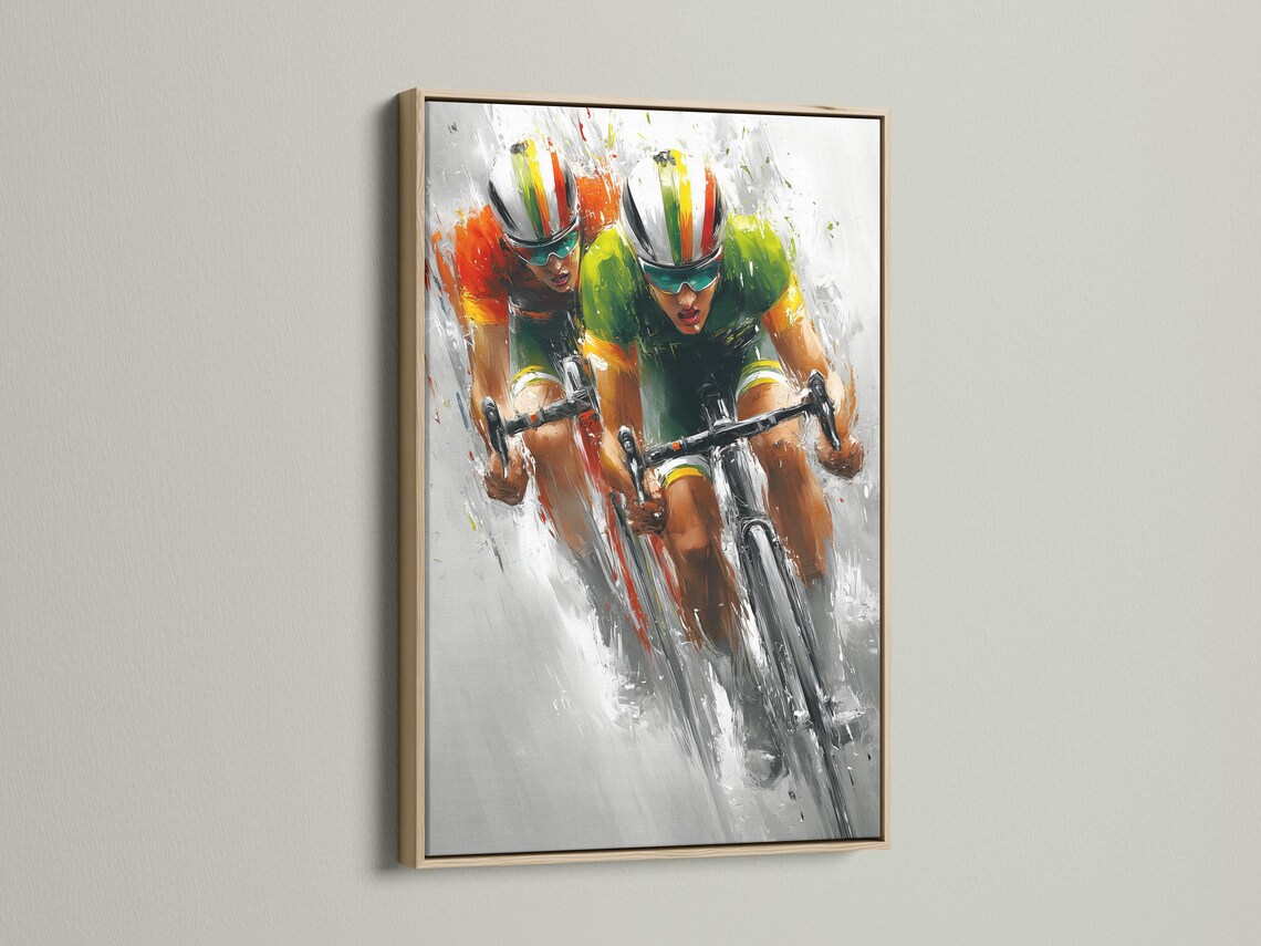 Cycling artwork mockup showing a framed print with two cyclists racing diagonally