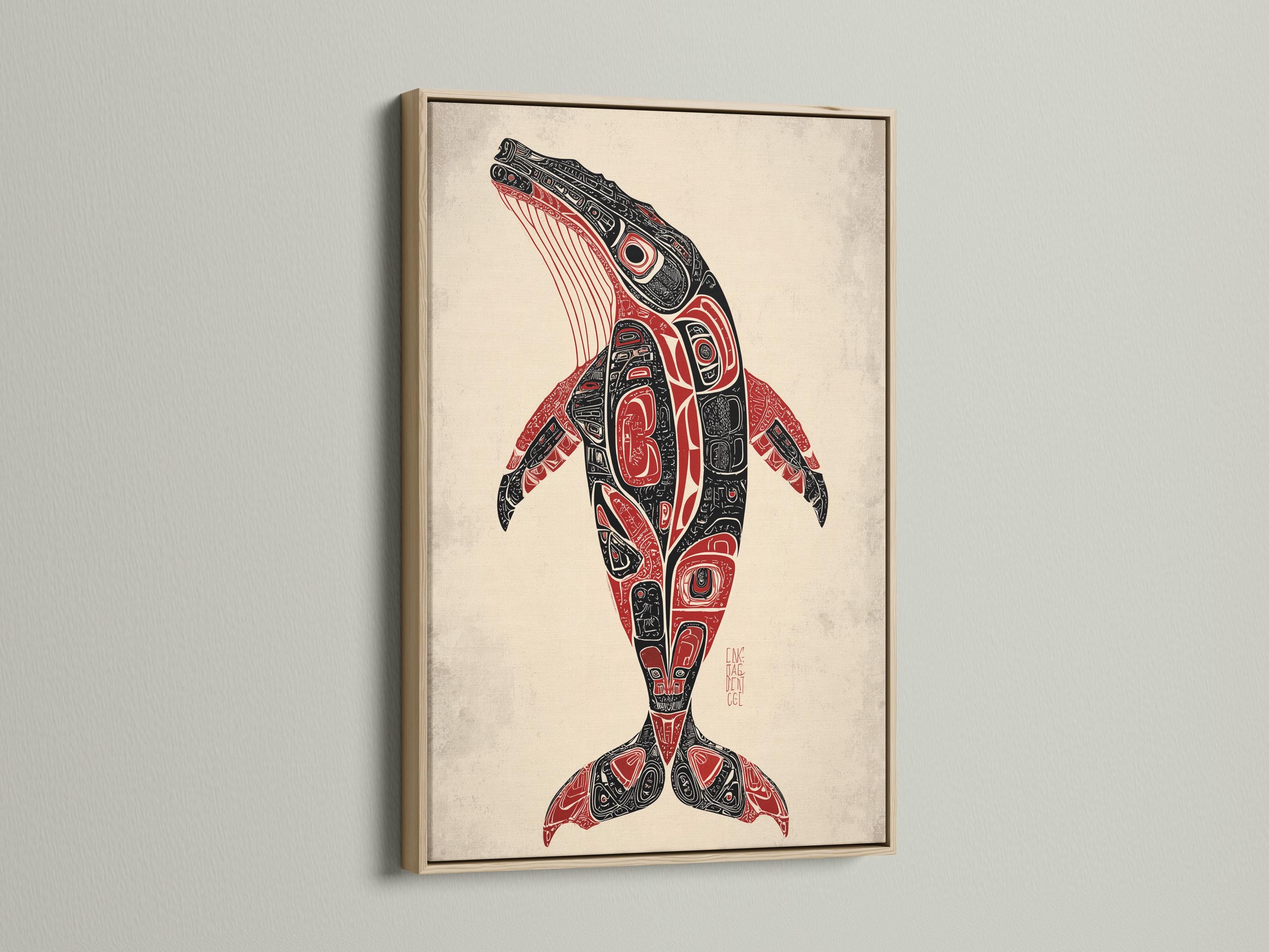 Man holding a mug beside a framed whale artwork in a rustic cabin setting
