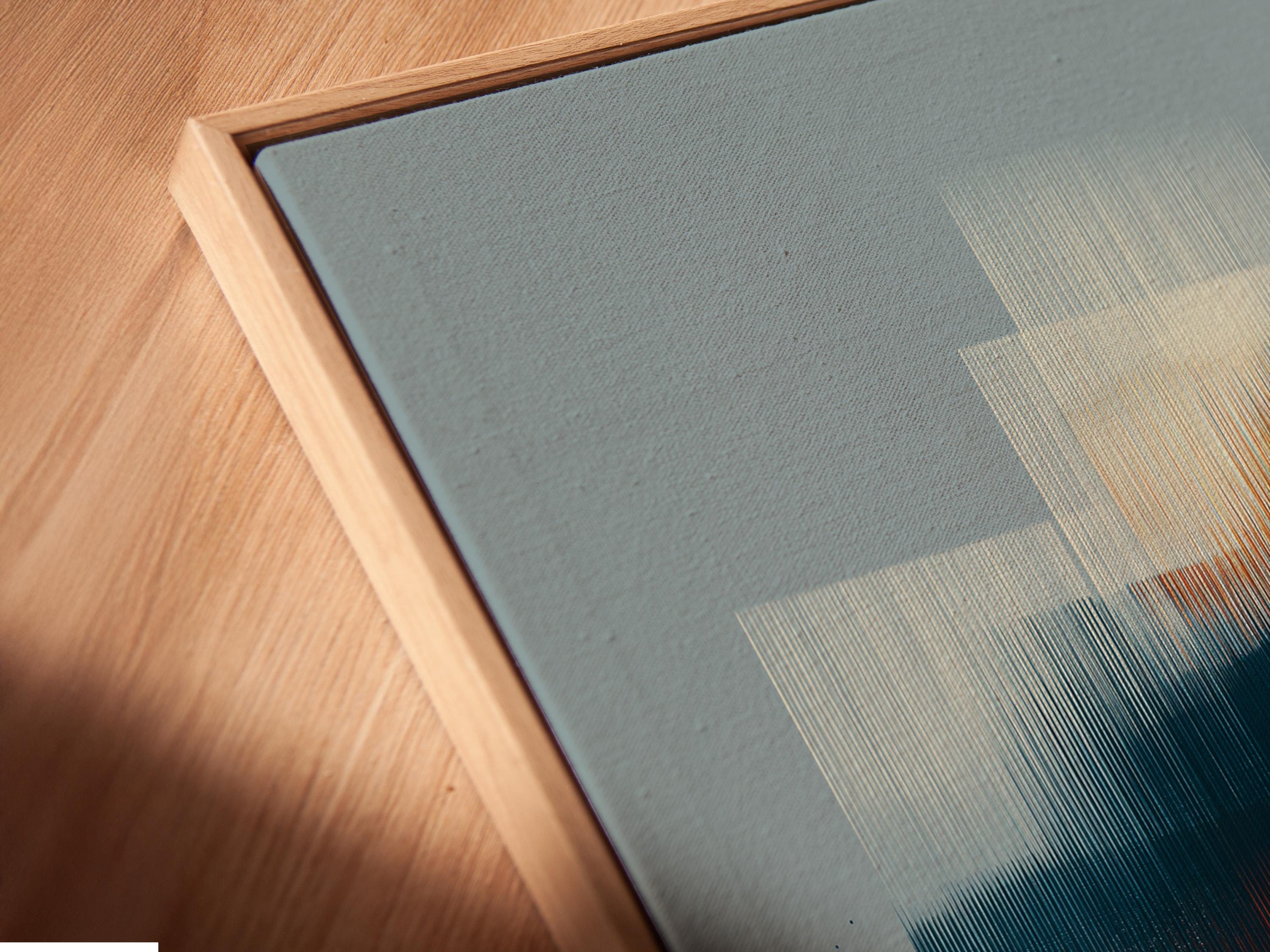 Abstract geometric wall art with layered blue rectangles and warm gold diagonal accents detail view