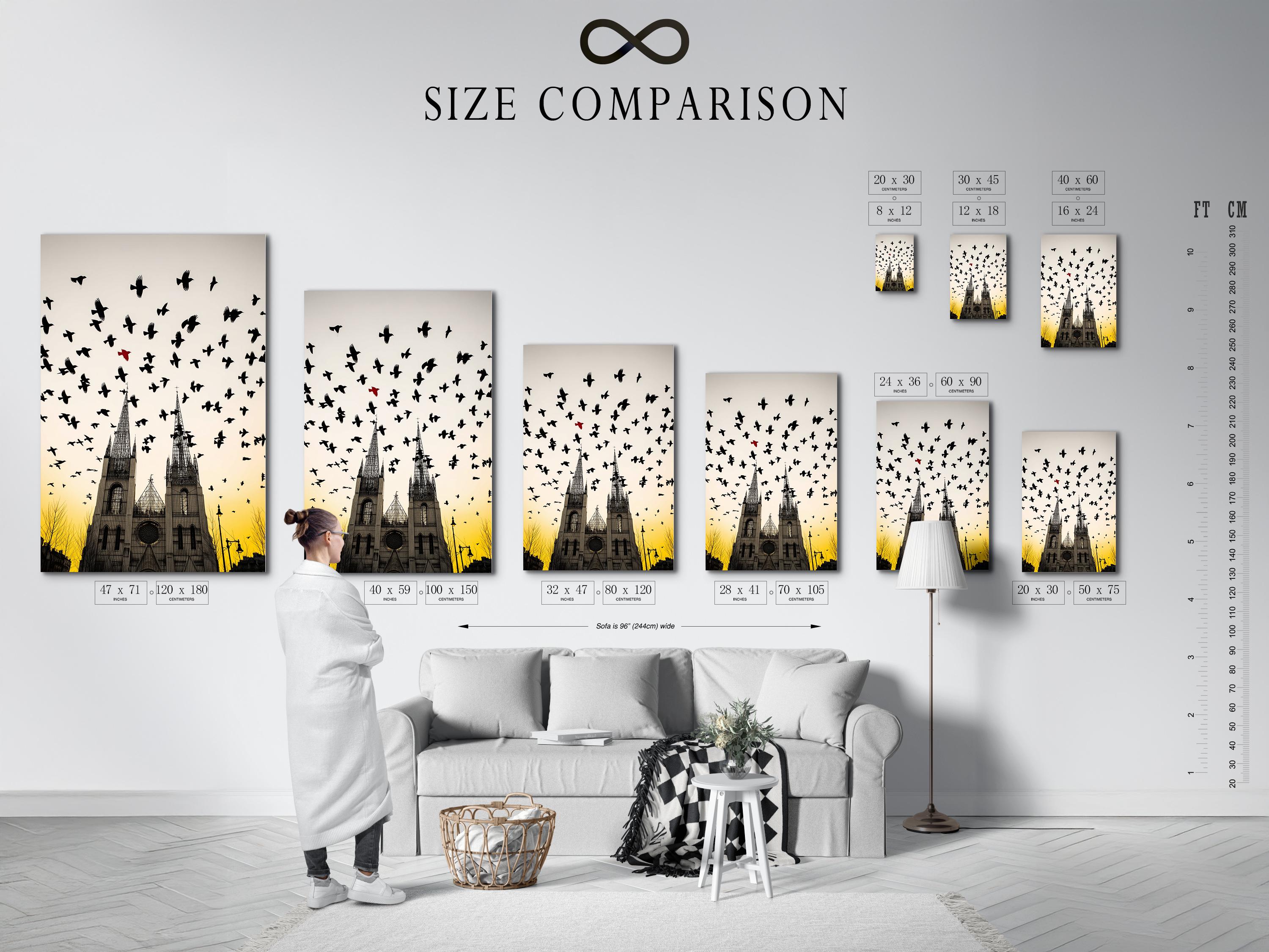 Gothic cathedral with silhouetted birds in flight above a warm ochre sunset sky detail view