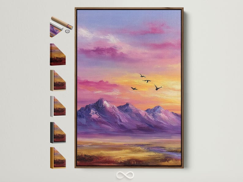 A framed mountain sunset illustration with purple, pink and gold skies and small black birds