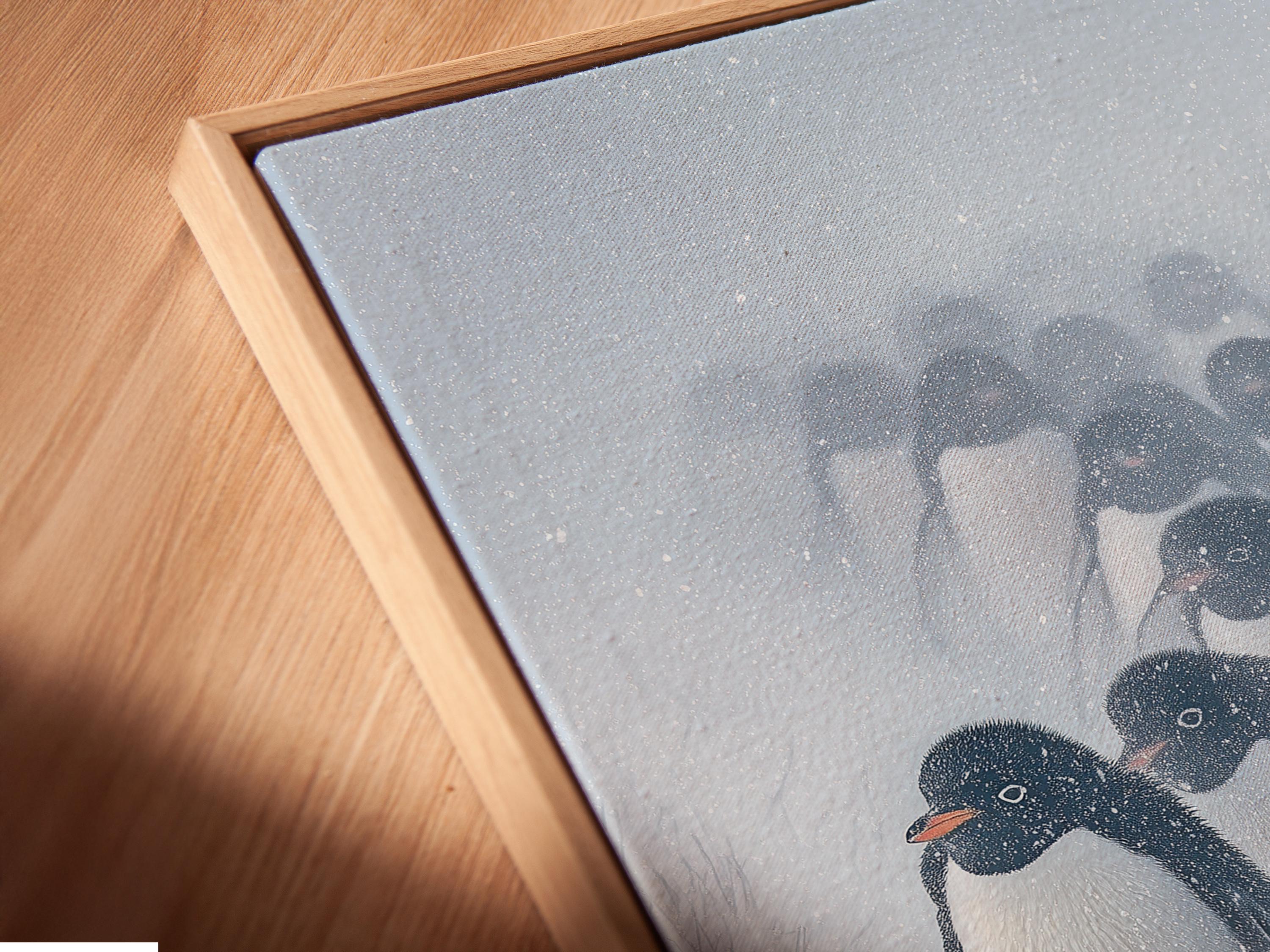 Snowy winter scene with a group of penguins in monochrome tones, with falling snow detail view