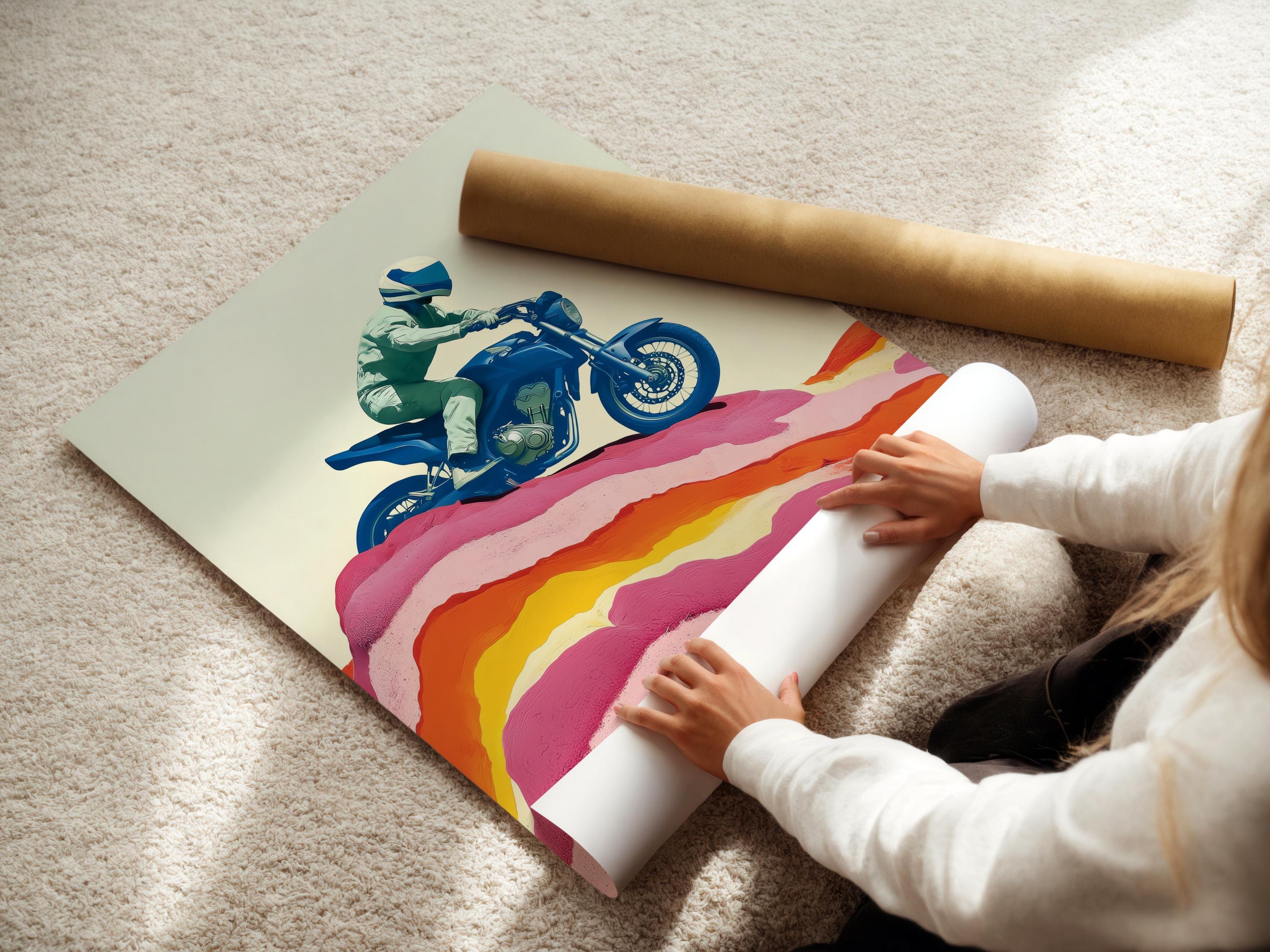 Framed wall mockup showing a stylised blue motorcycle rider over pink and orange mountain ridges