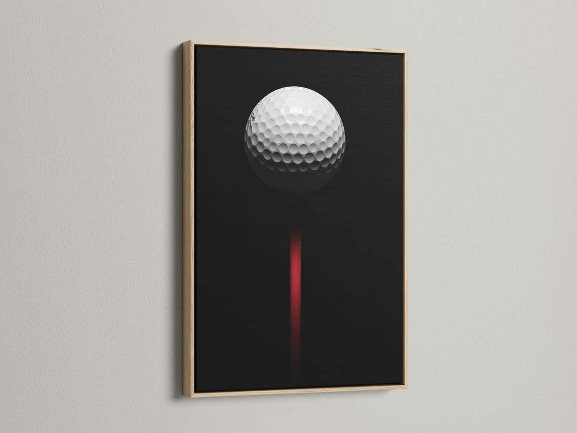 Minimalist golf ball design on a black background with a vivid red vertical accent detail view