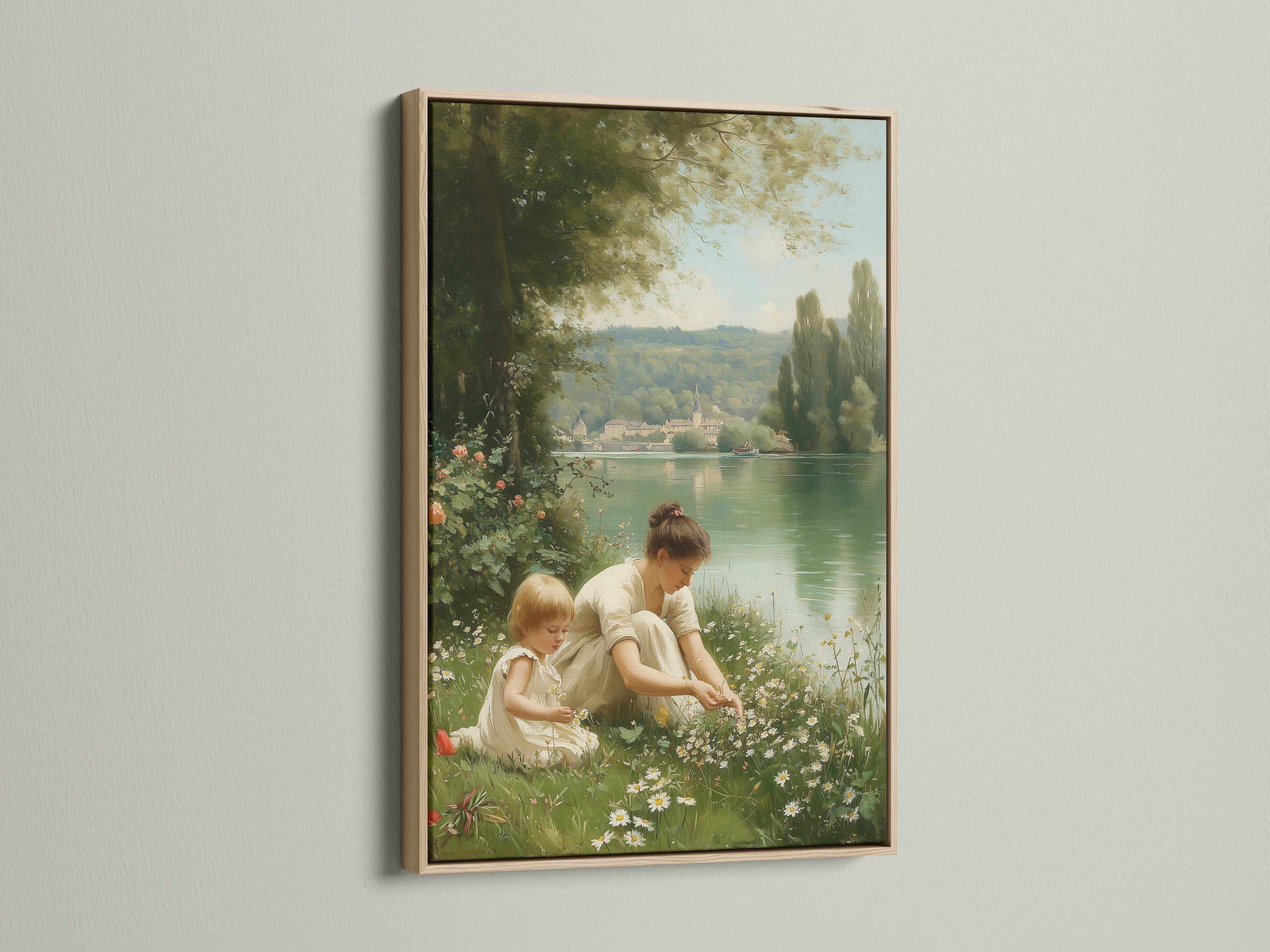 Mother and child sitting in a meadow by a calm lake with trees and distant buildings detail view