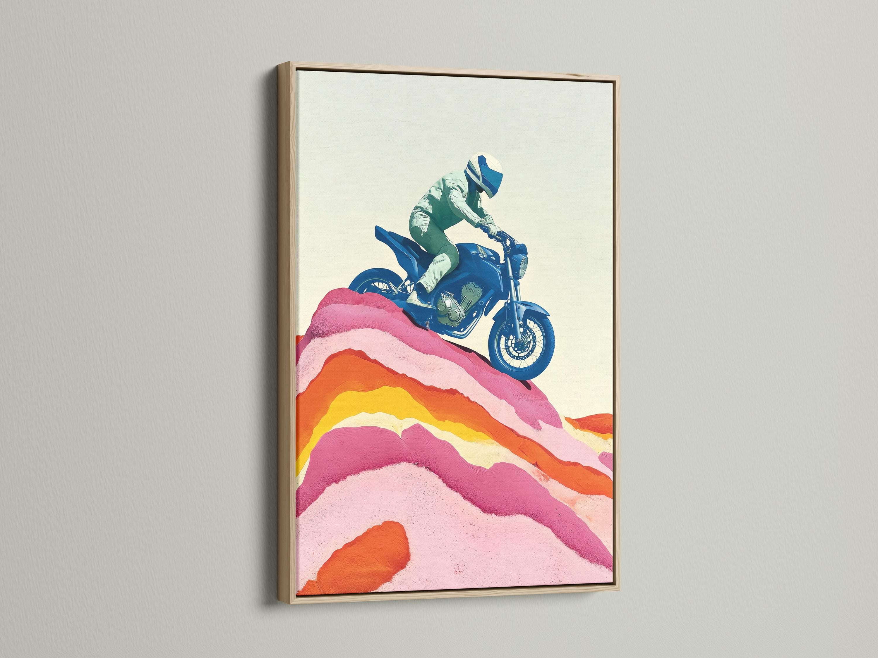 Framed wall mockup showing a stylised blue motorcycle rider over pink and orange mountain ridges