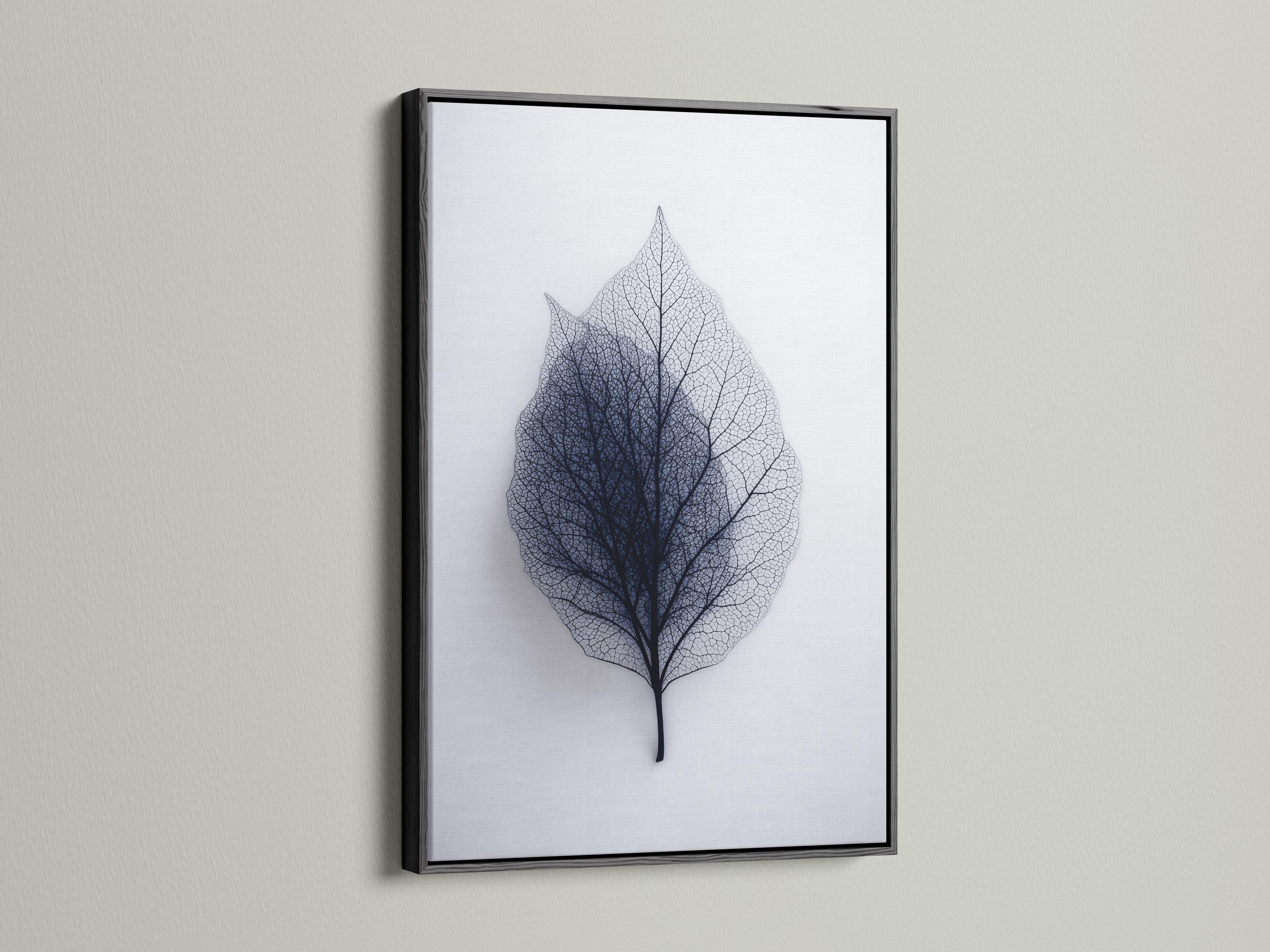 A person looking at a framed leaf skeleton wall artwork in a bright room