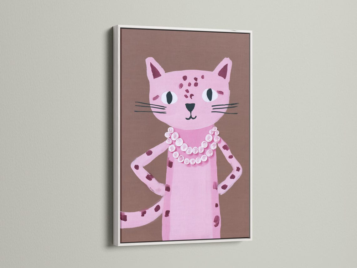 Portrait of a pink cat with large eyes and a white and pink rosette collar on a taupe background detail view