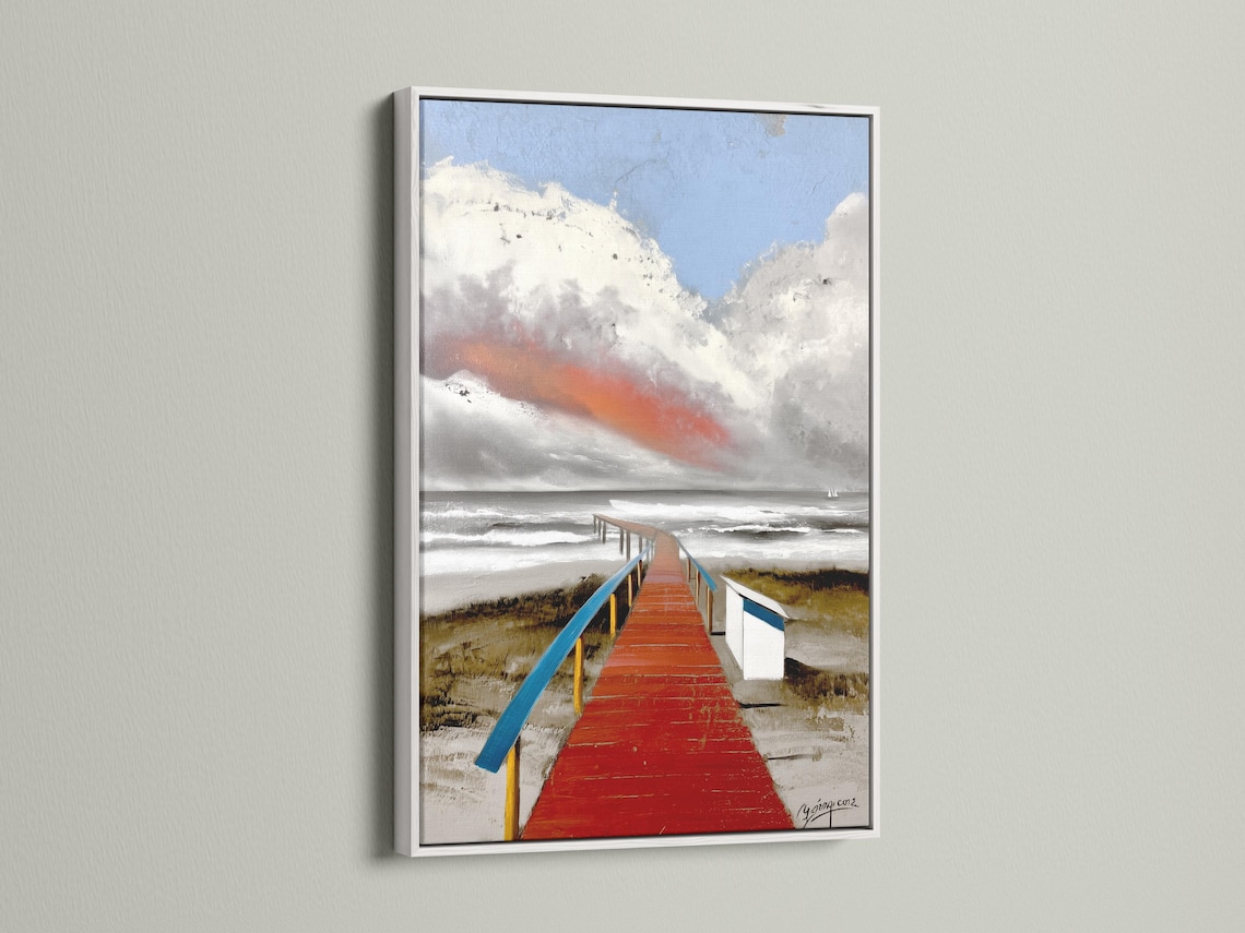 Red boardwalk leading to the sea with blue rails, waves and a cloudy sky detail view