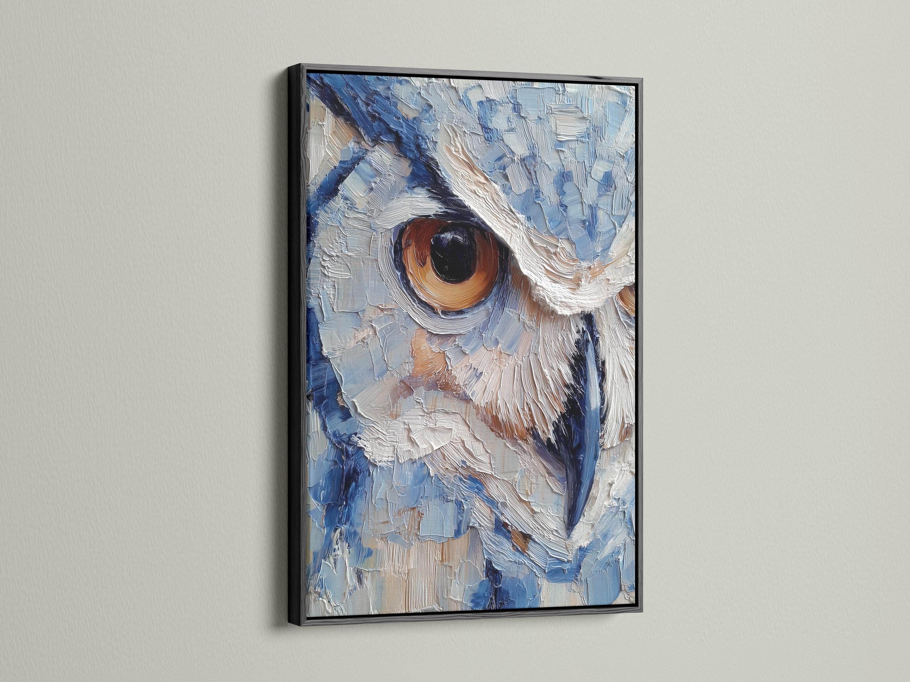 Room scene with a framed blue owl painting above a desk where a person writes in a book