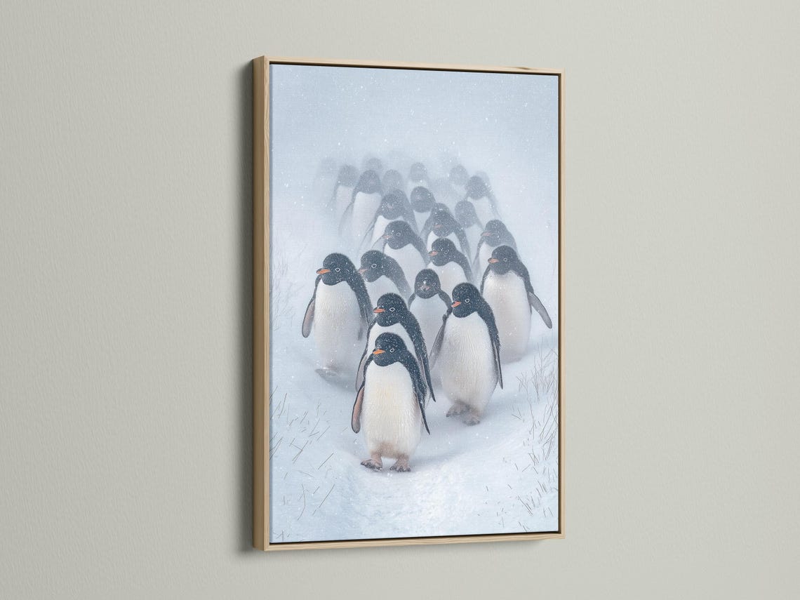 Penguin winter wall art shown in a framed mockup with snow background
