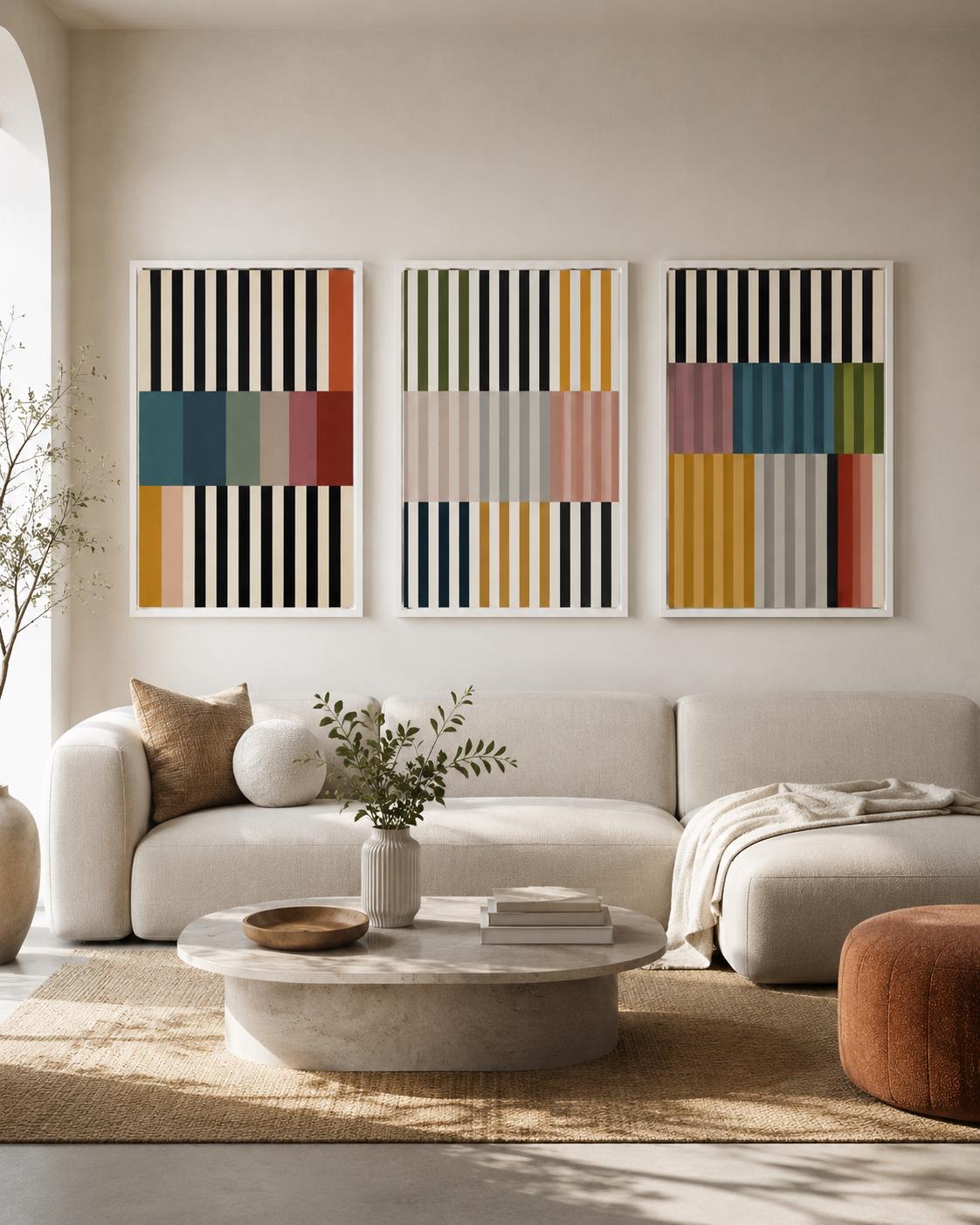 Living room scene featuring three framed geometric stripe artworks