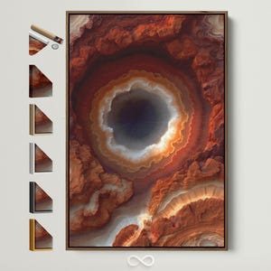 Puede incluir: Impresión artística en lienzo enmarcado abstracto, que representa una vista de cerca de una formación geológica. La obra de arte presenta un patrón circular central azul oscuro y blanco, rodeado de capas de naranja, rojo y blanco.