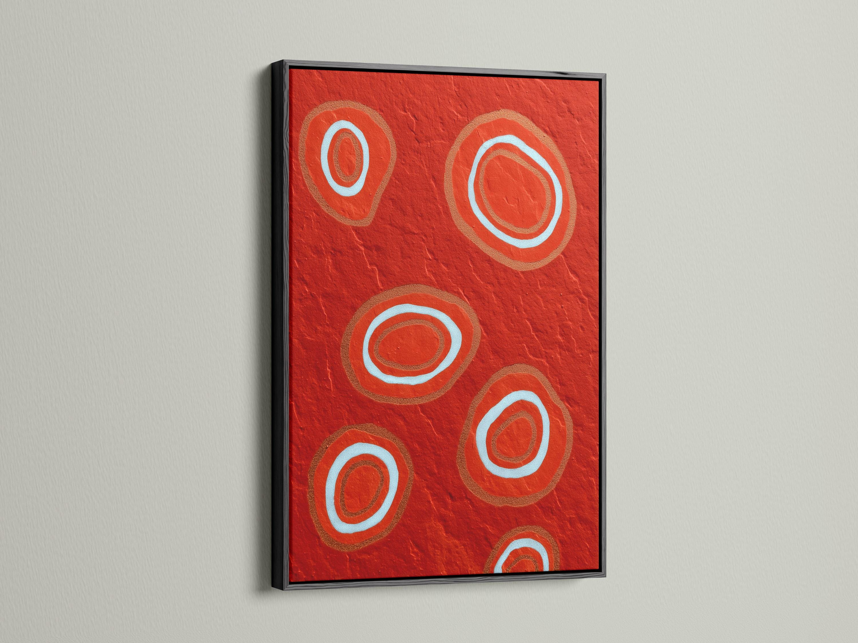 Room mockup showing a red abstract artwork with concentric circle motifs in pale blue and copper tones