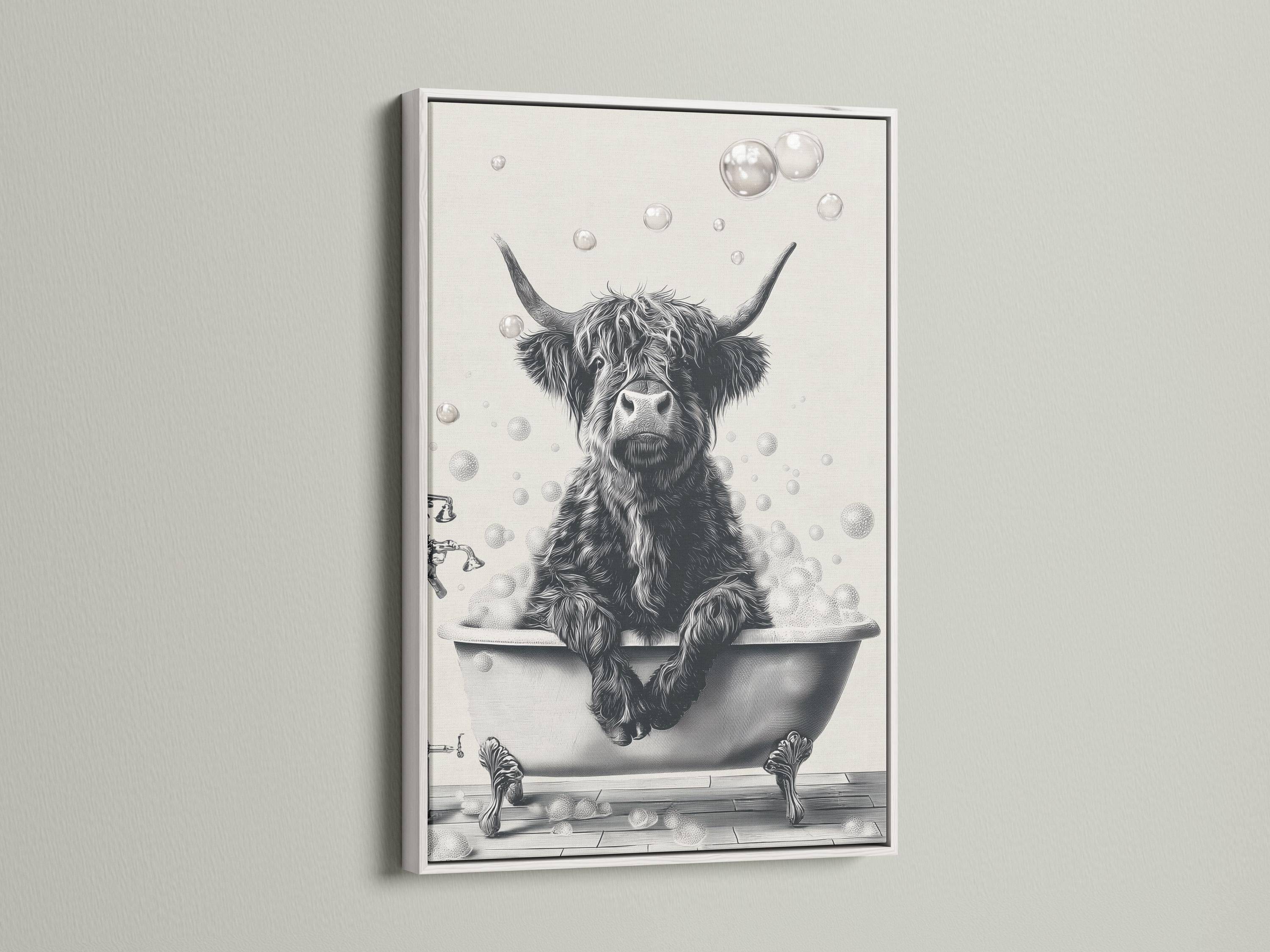 Woman holding a mug standing beside a framed monochrome highland cow bathtub artwork