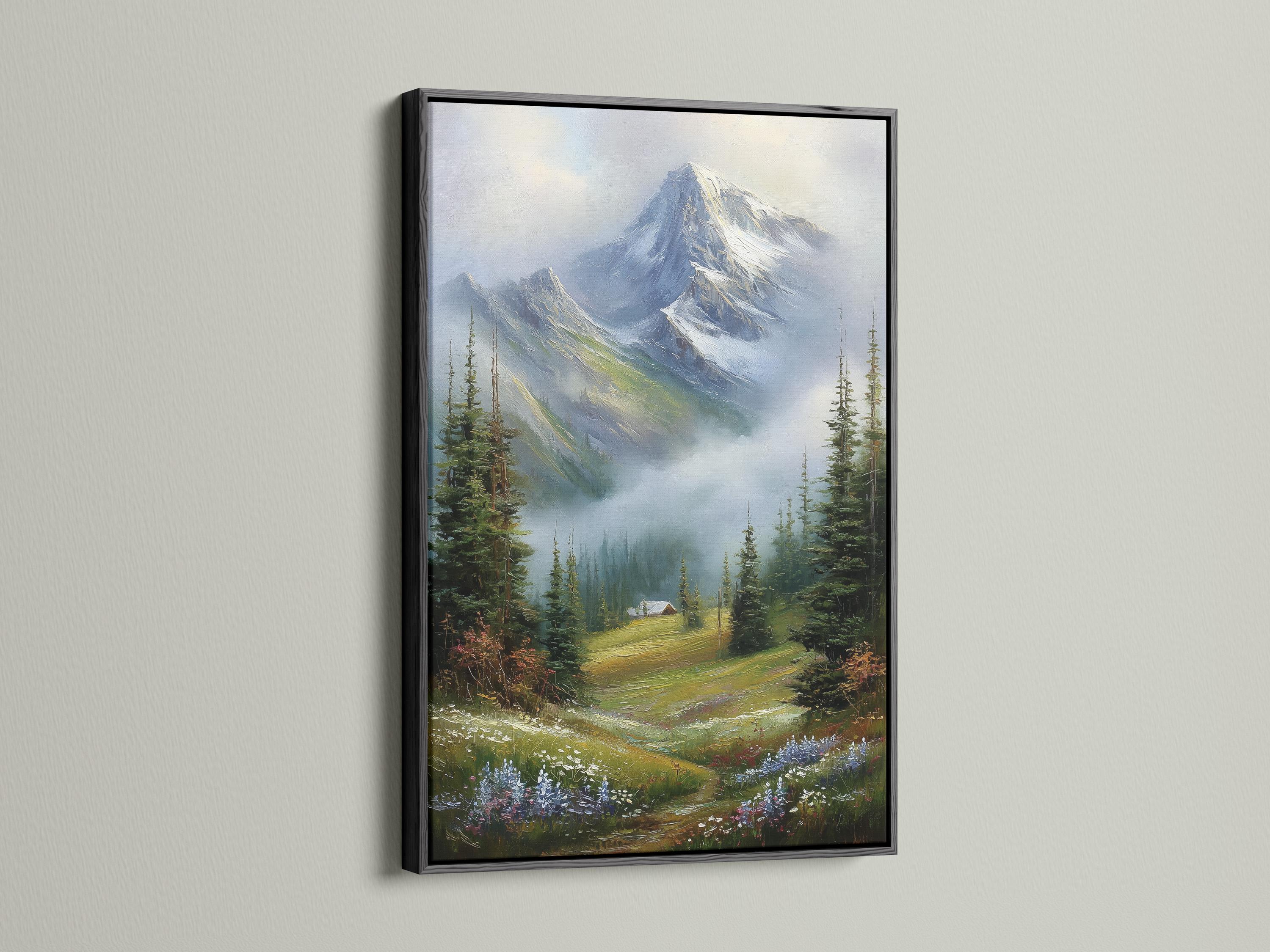Room mockup showing a framed snowy mountain landscape painting with evergreen trees and a cabin