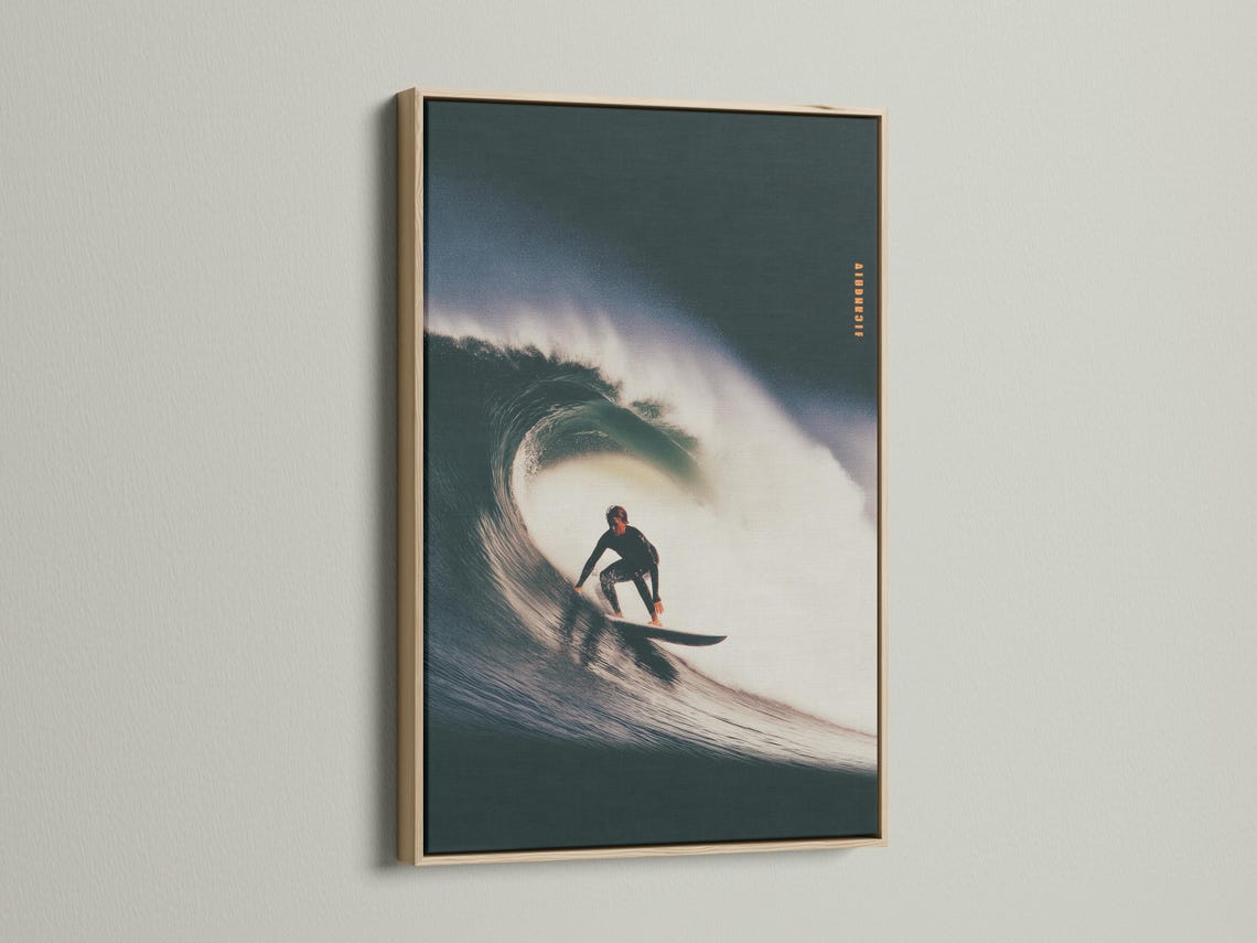 Surfer riding a curling wave, shown in dark teal ocean tones with bright white foam and spray mist detail view