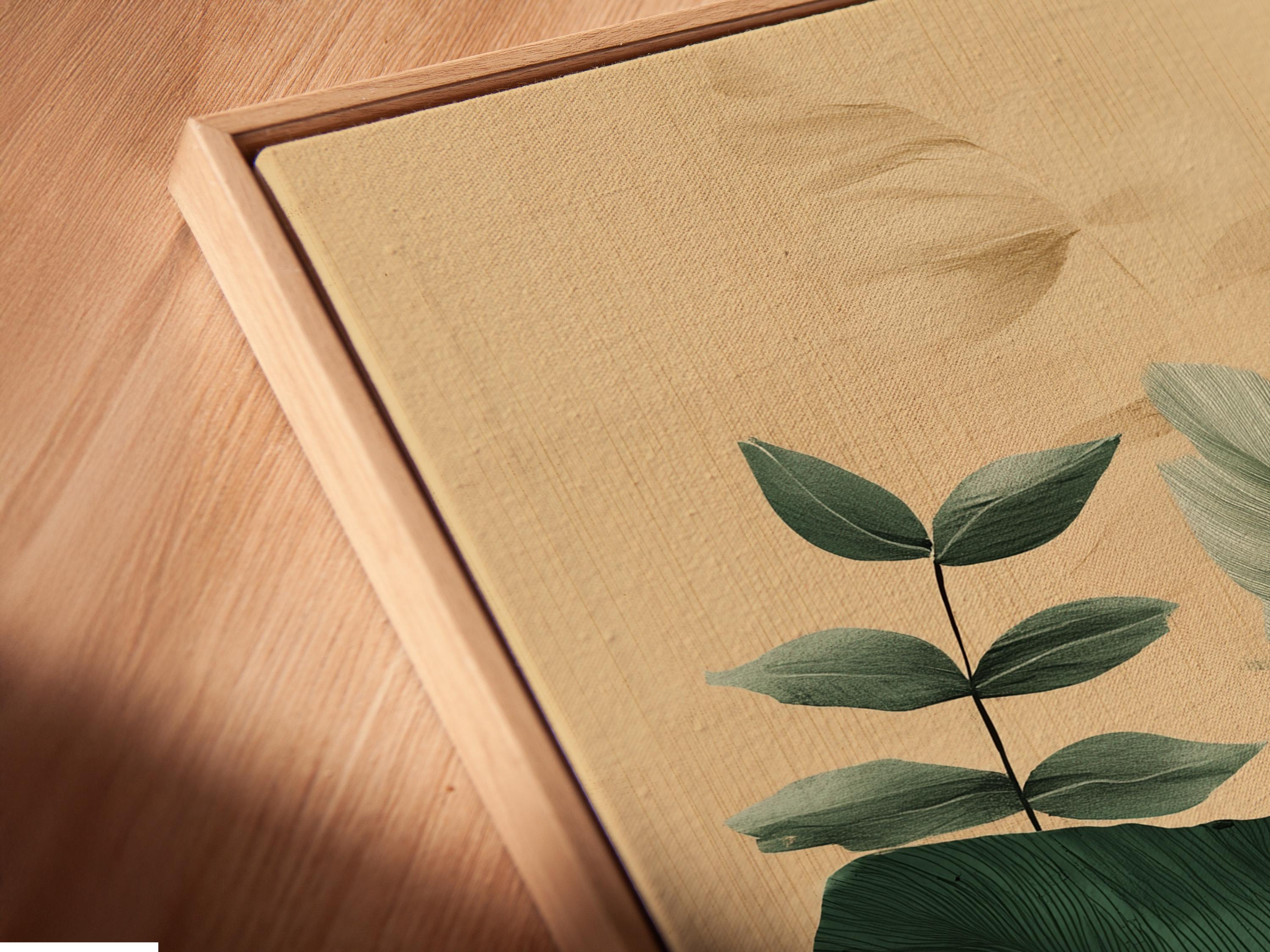 Framed botanical artwork featuring tropical leaves in green and teal on a beige background
