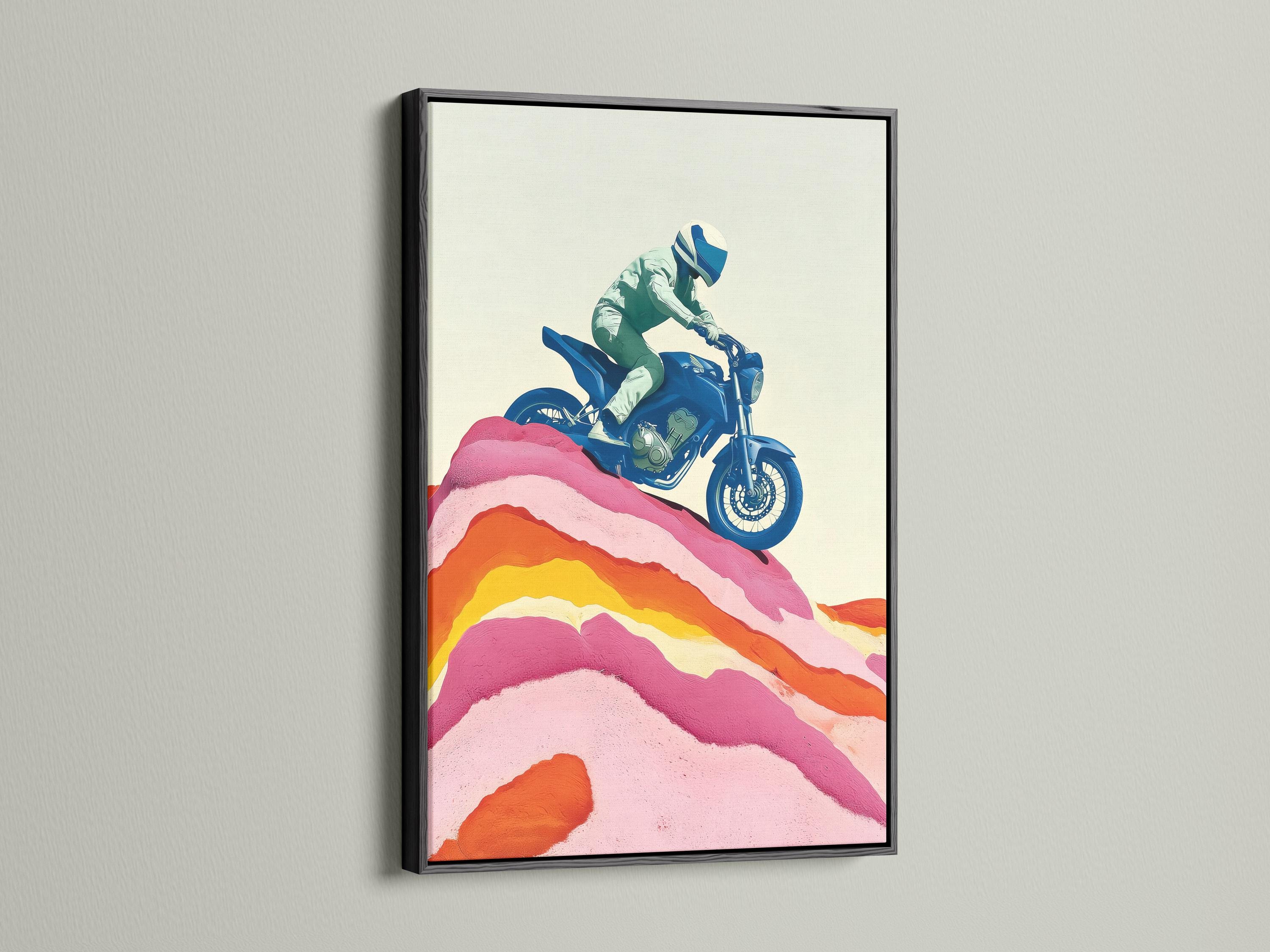 Framed wall mockup showing a stylised blue motorcycle rider over pink and orange mountain ridges