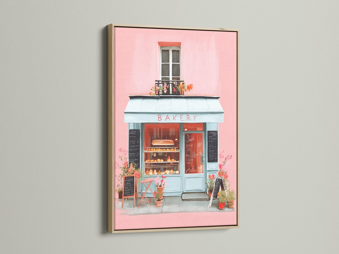 Room mockup showing a framed pastel bakery shopfront illustration