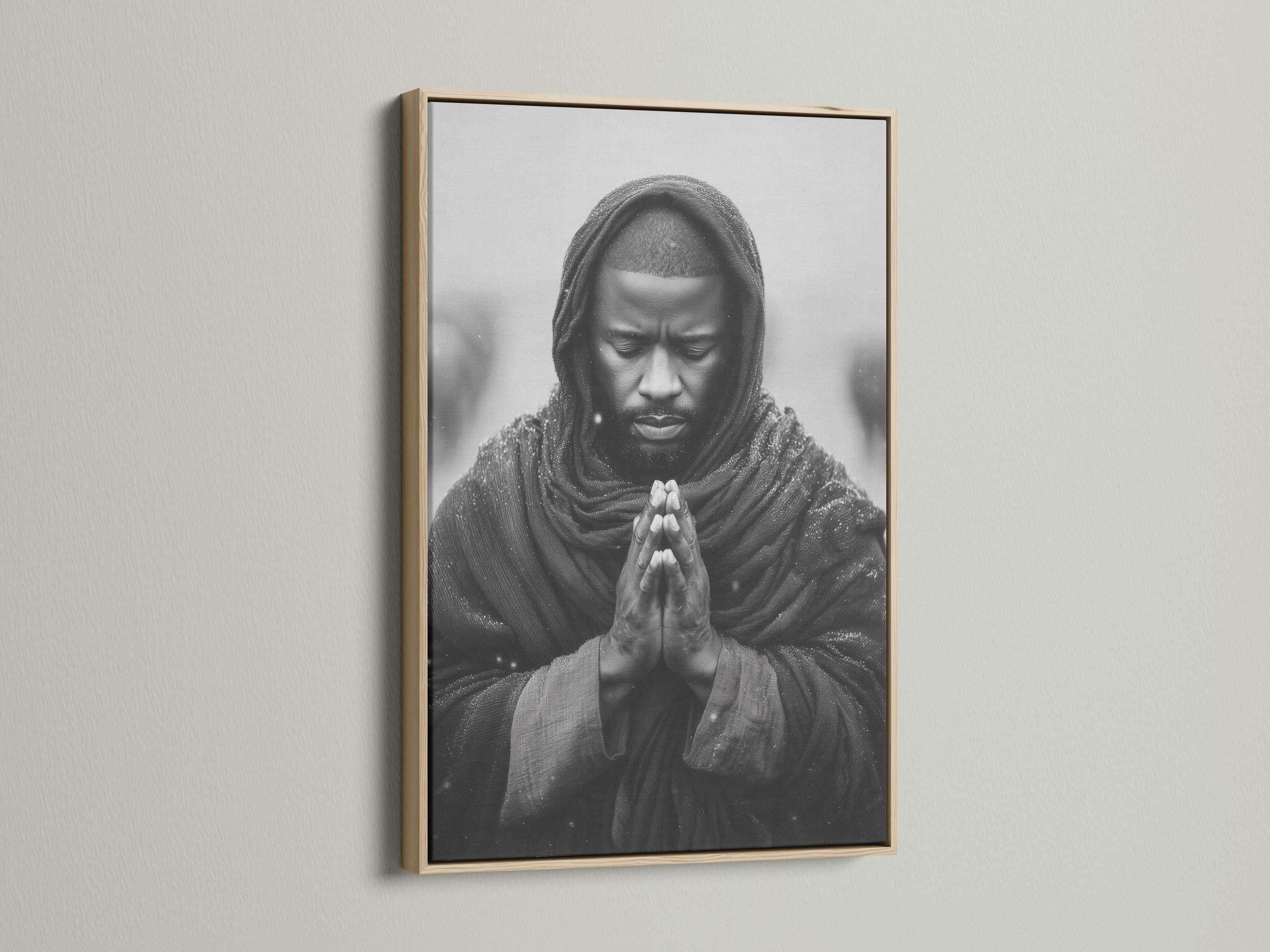 Room mockup showing a framed monochrome praying man portrait on a light background