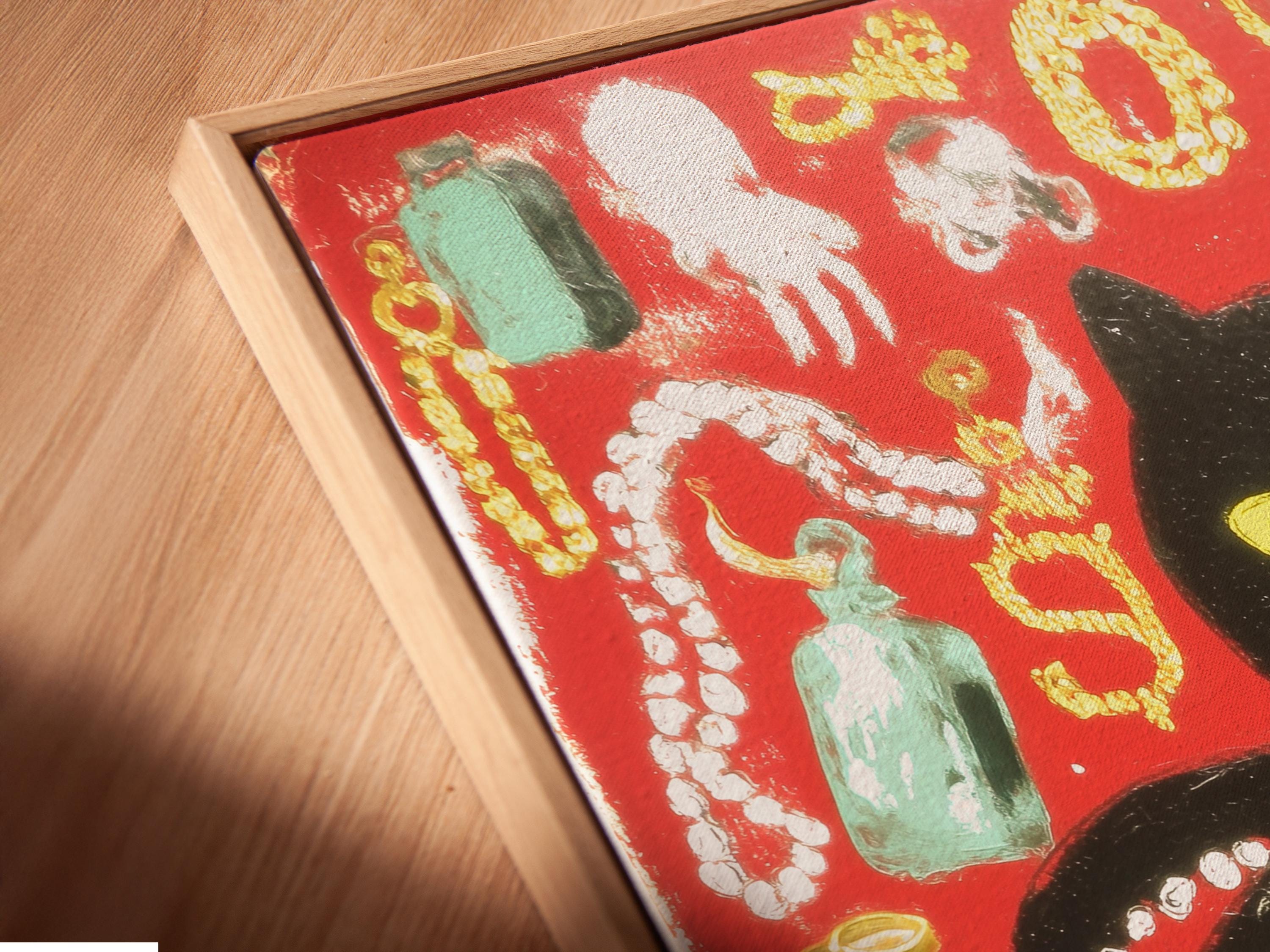 Black cat with yellow eyes in a red octopus-like animal collage with gold and bead-like details detail view
