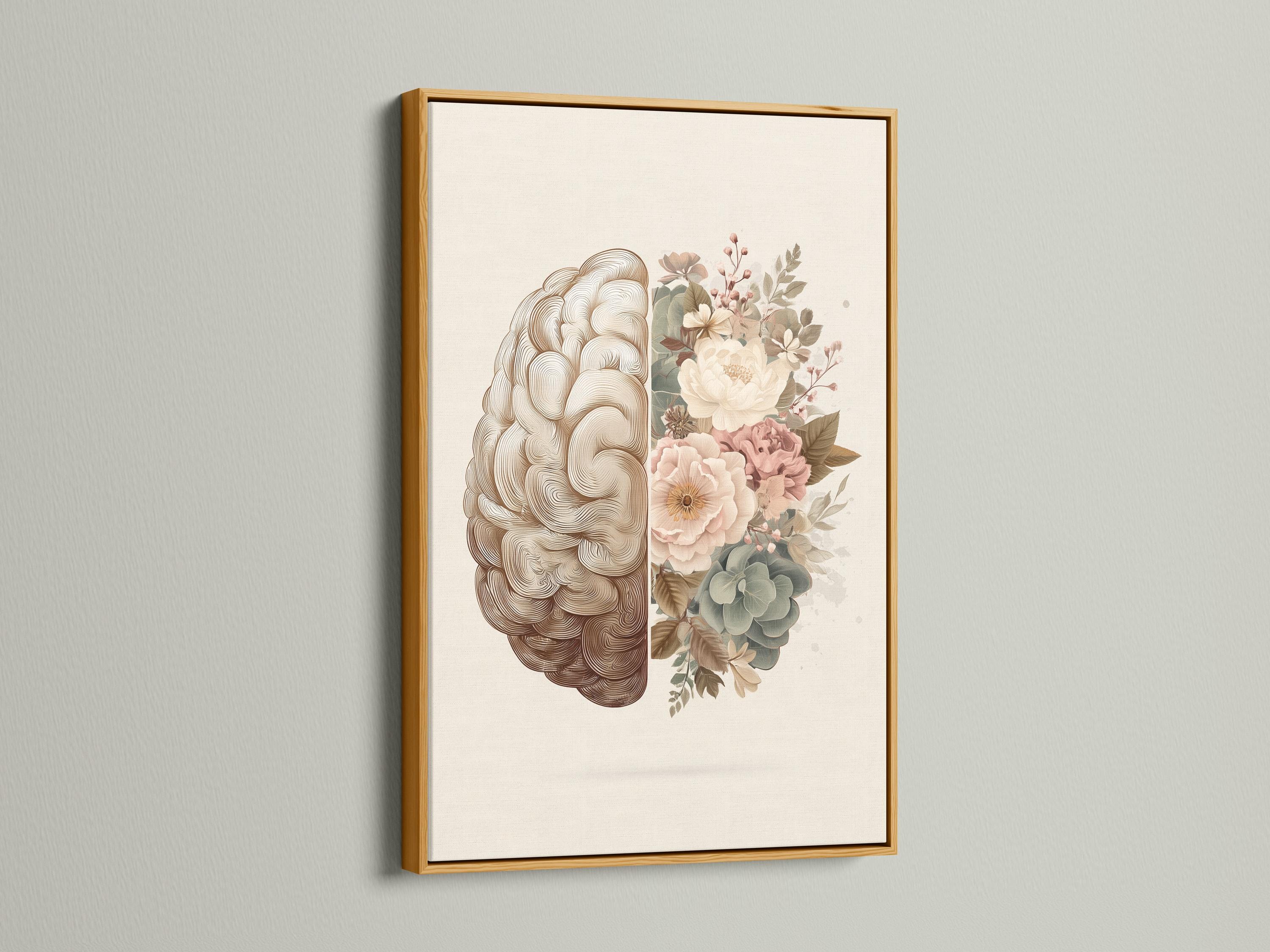 Person reading beside a framed split brain and floral artwork on a floor in a softly lit room